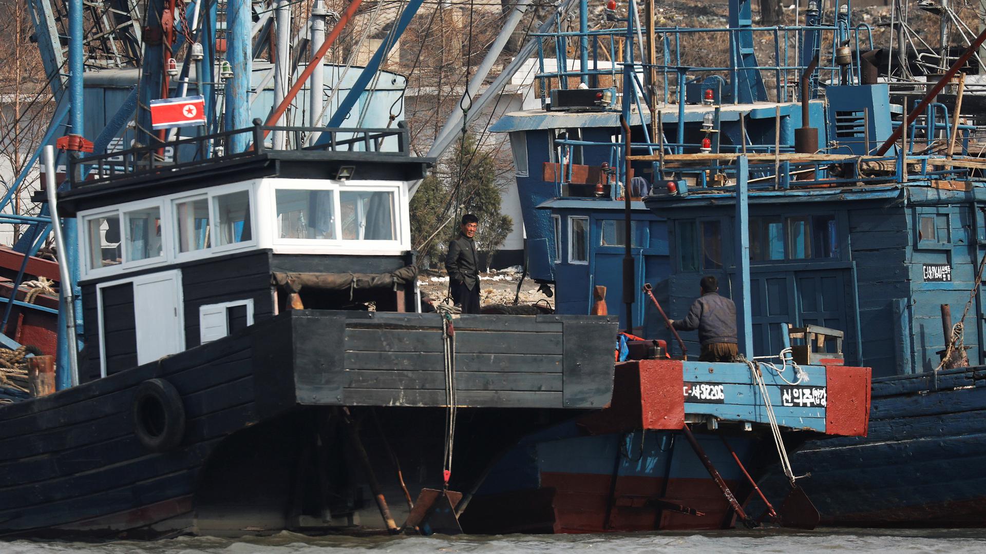 People work on boats at the port near the North Korean town of Sinuiju.