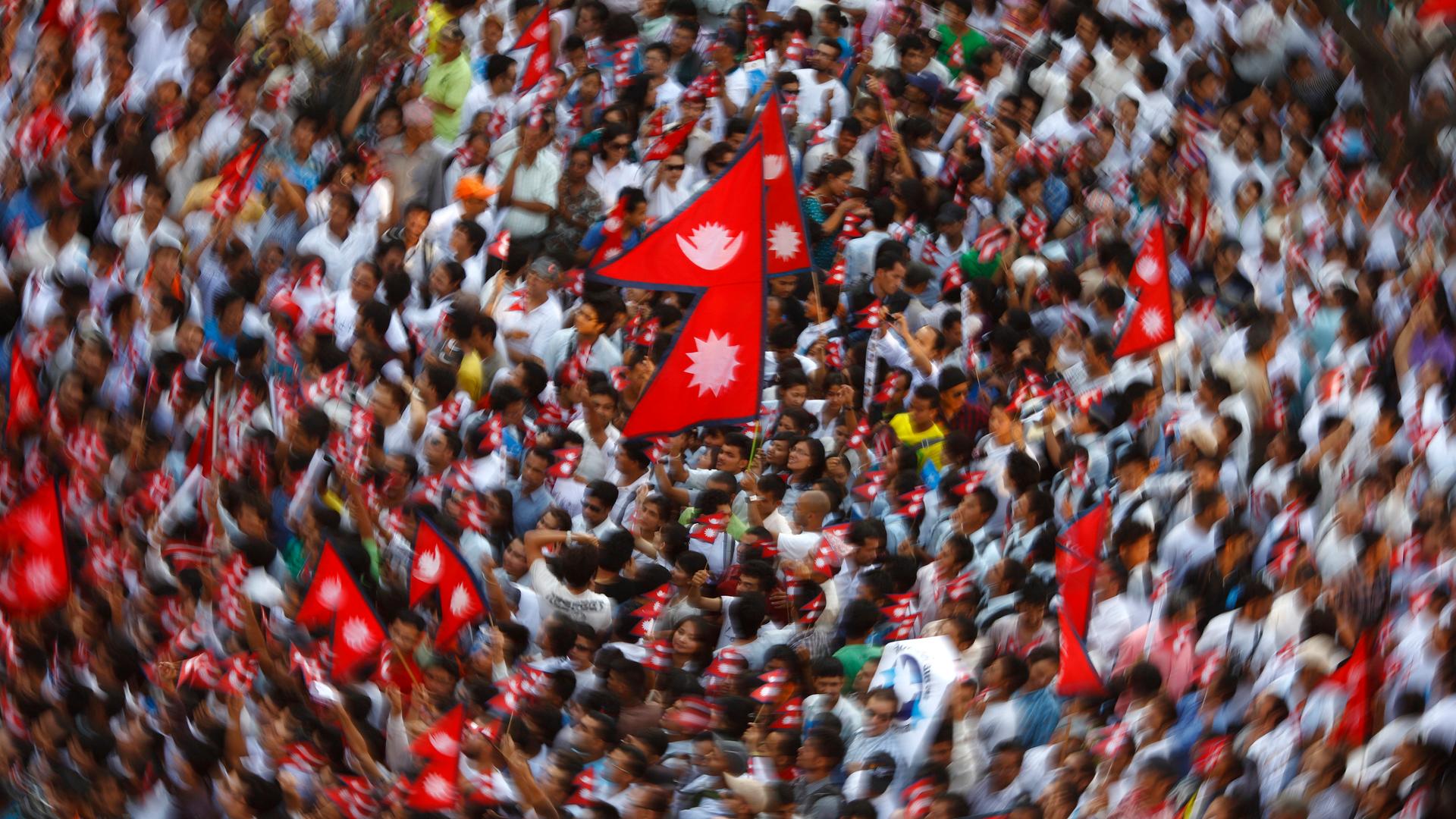 Demonstrators carrying the national flag of Nepal.