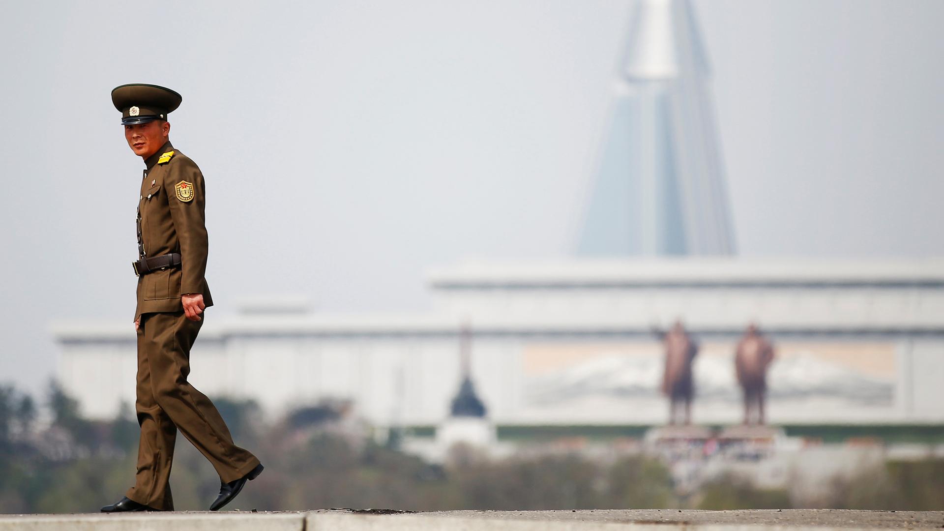 A soldier walks on the bank of the river in central Pyongyang, North Korea.