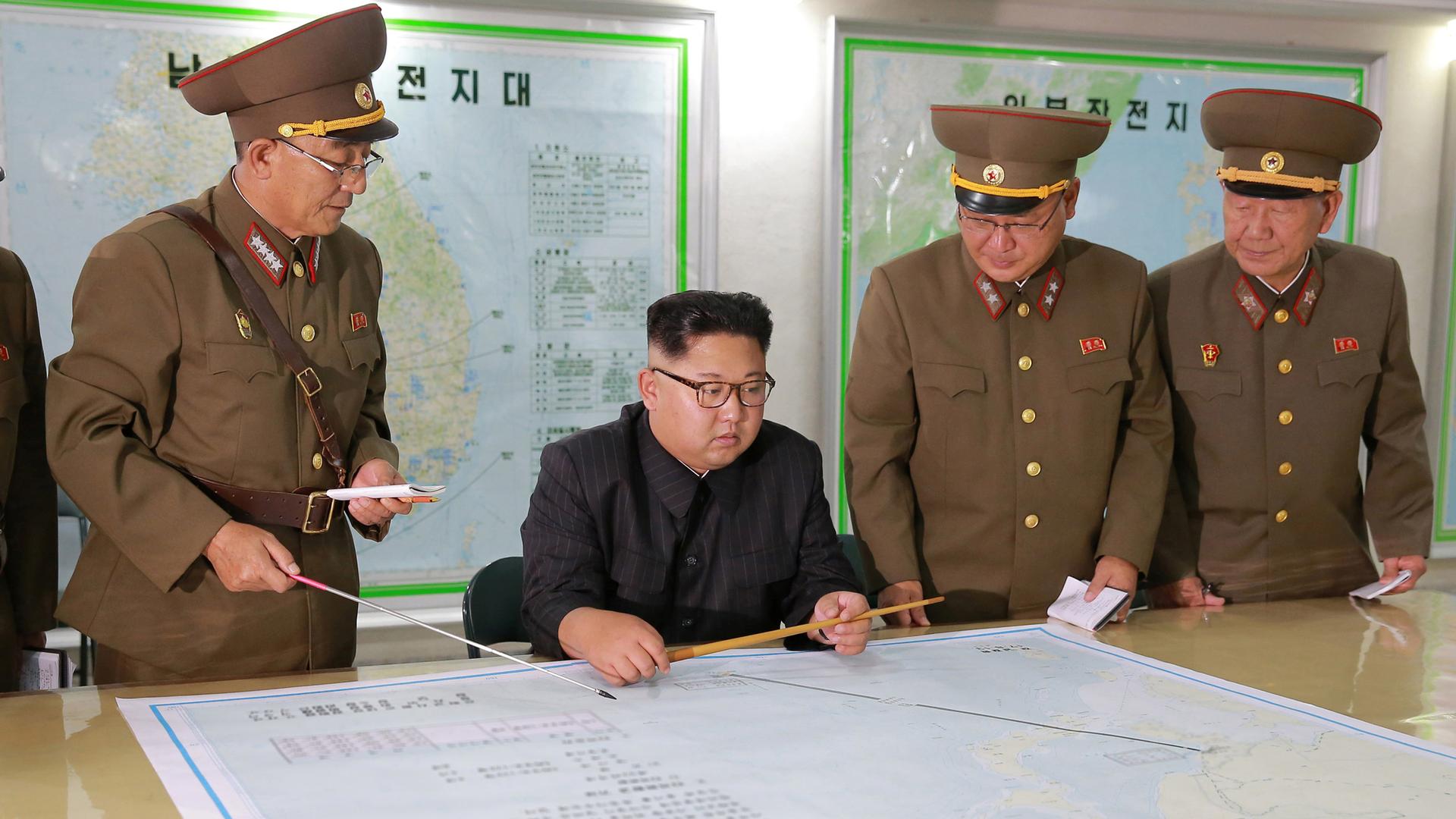 North Korean leader Kim Jong-un with military officials in an unknown location in an undated photo released by North Korea's Korean Central News Agency on August 15, 2017.