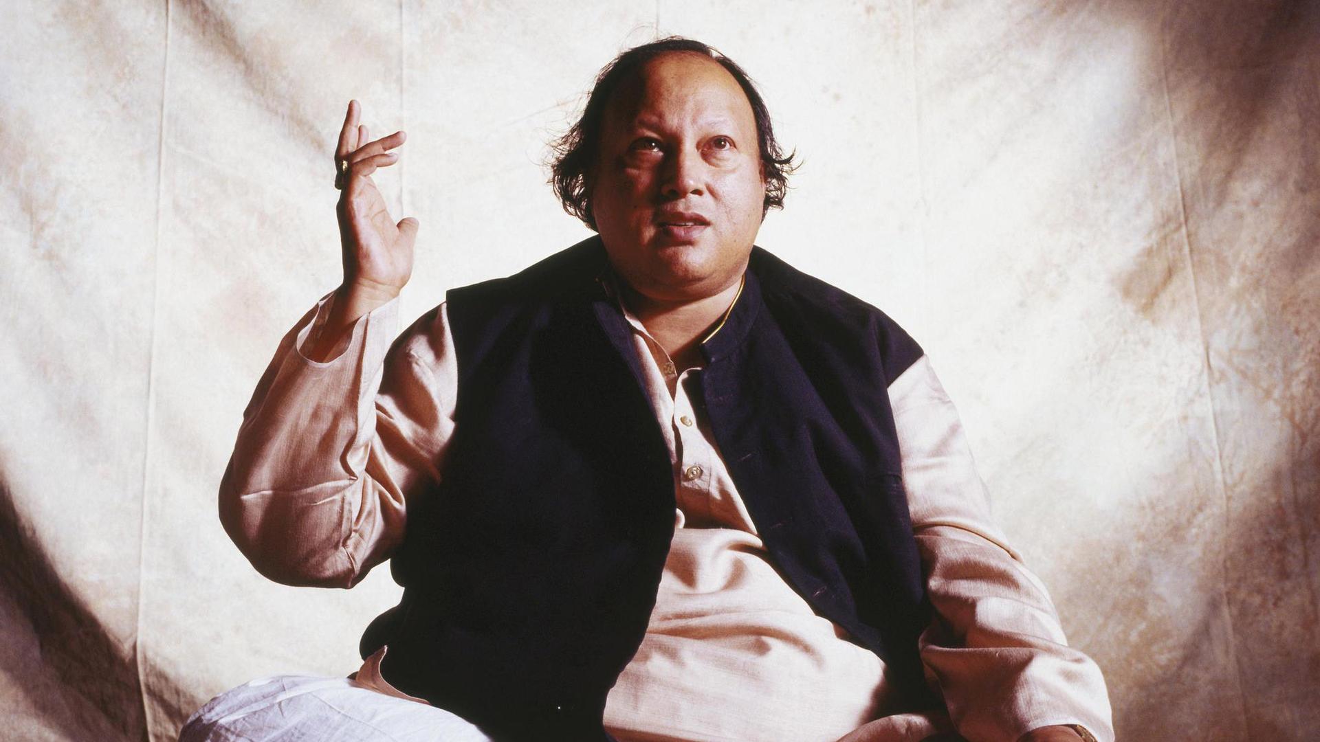 Nusrat Fateh Ali Khan, the Pakistani singer who is known for bringing Qawwali music to a global audience.