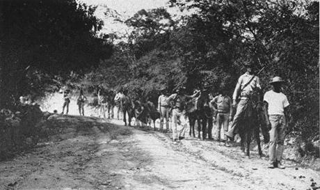 US Marines on patrol in 1915 during the occupation of Haiti. A Haitian guide is leading the party.