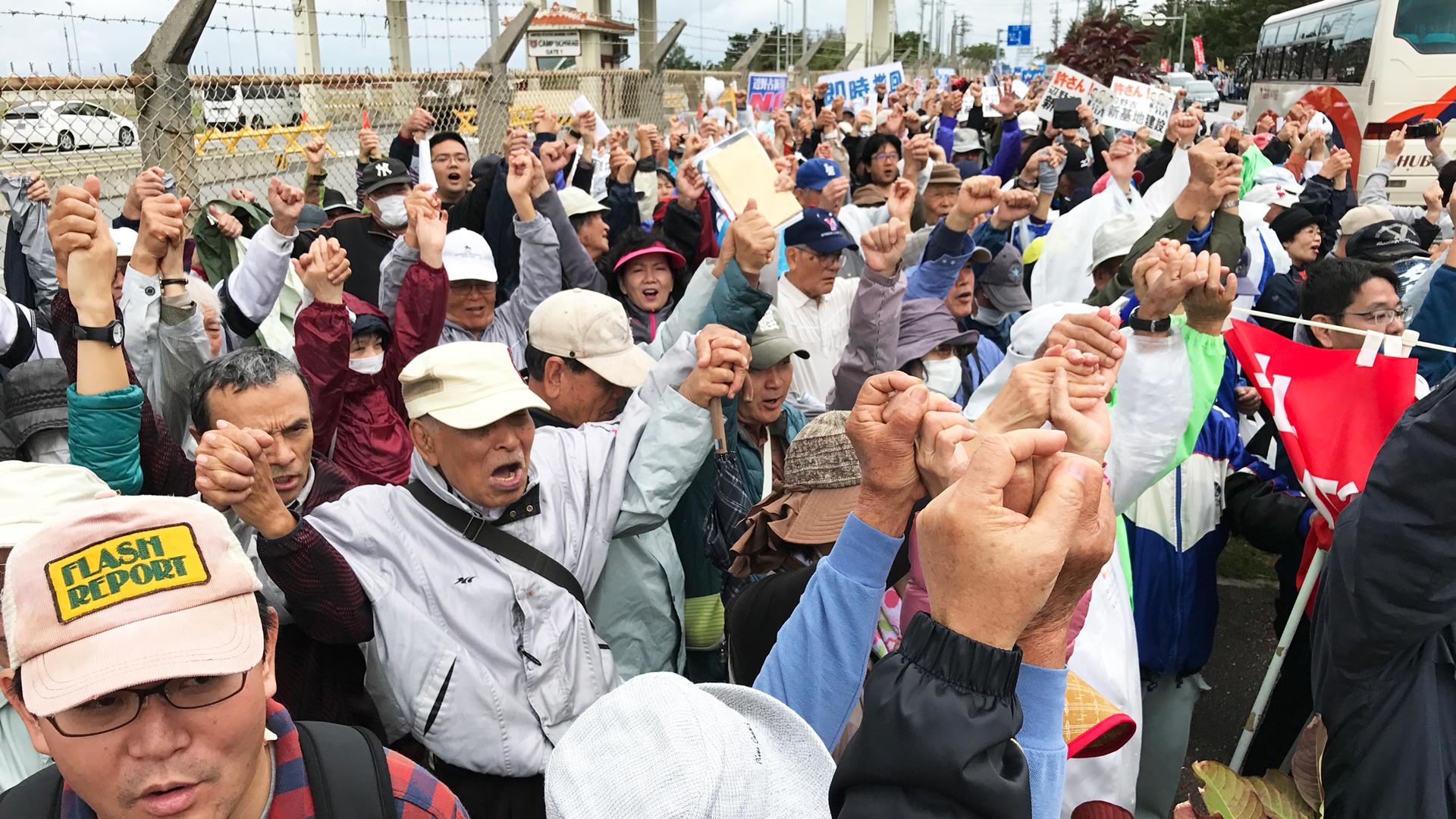 Protesters demonstrate outside a US Marine base on Okinawa. The US plans to greatly expand the base in the rural fishing village of Henoko.