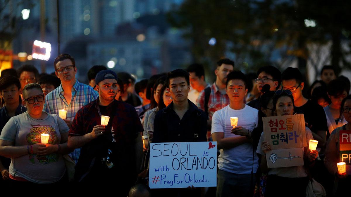 People attend a candlelight vigil in solidarity for the victims of the Orlando gay nightclub mass shooting, in Seoul, South Korea.