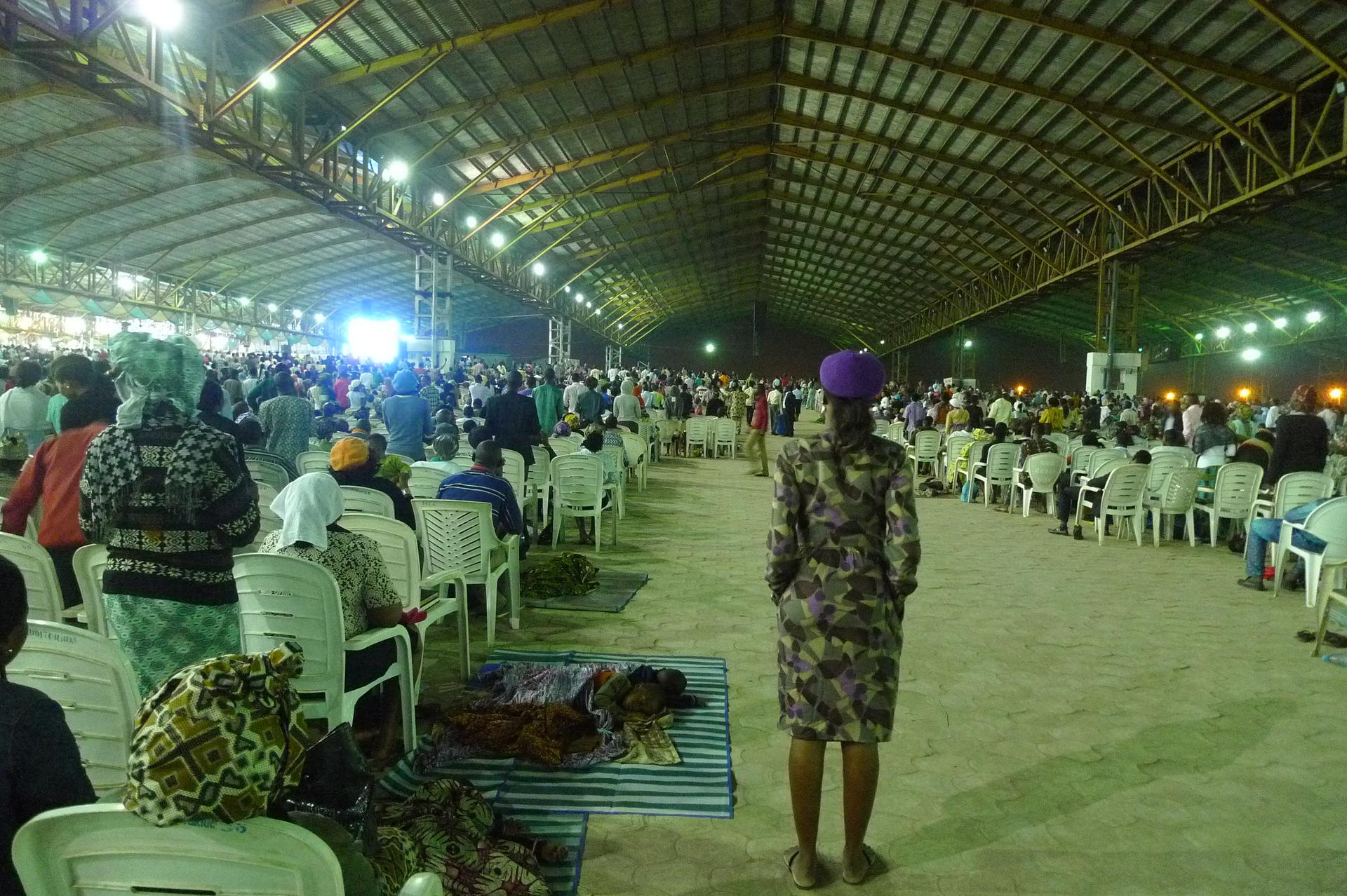 Under an open-air pavilion built to seat a million people, children sleep on mats spread out on the cobblestones while their parents enter their 6th consecutive hour of worship.