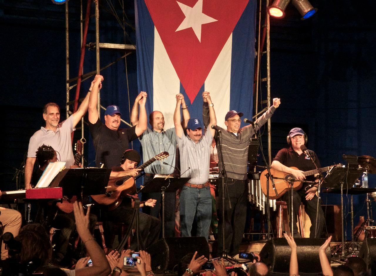 The "Cuban Five," a group of five intelligence officers recently returned to Cuba in an exchange with the United States, celebrate on stage with musical artist Silvio Rodriguez.
