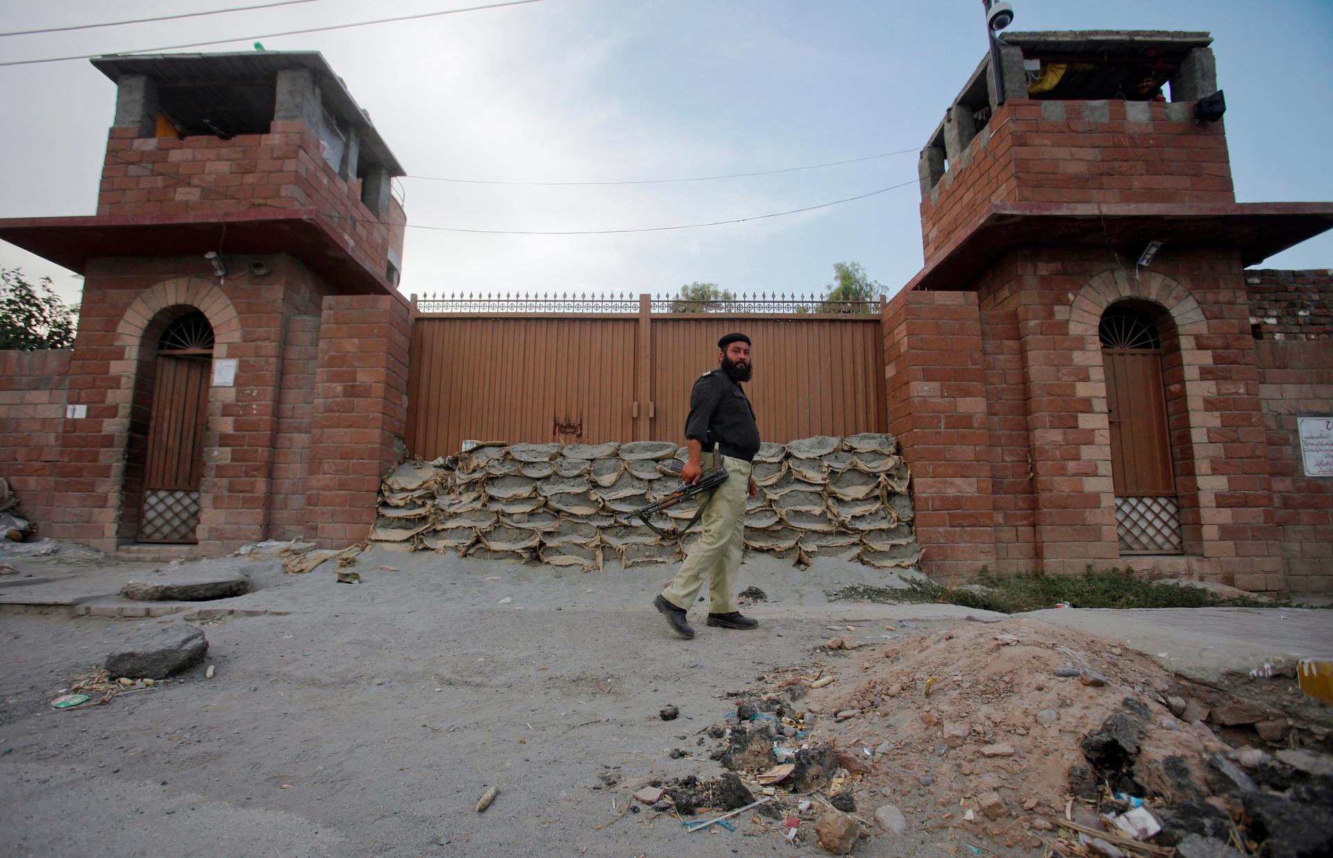 A police officer walks past Central Jail in Peshawar where Pakistani doctor Shakil Afridi now sits. Afridi was arrested in May 2011 for helping the CIA find Osama bin Laden.