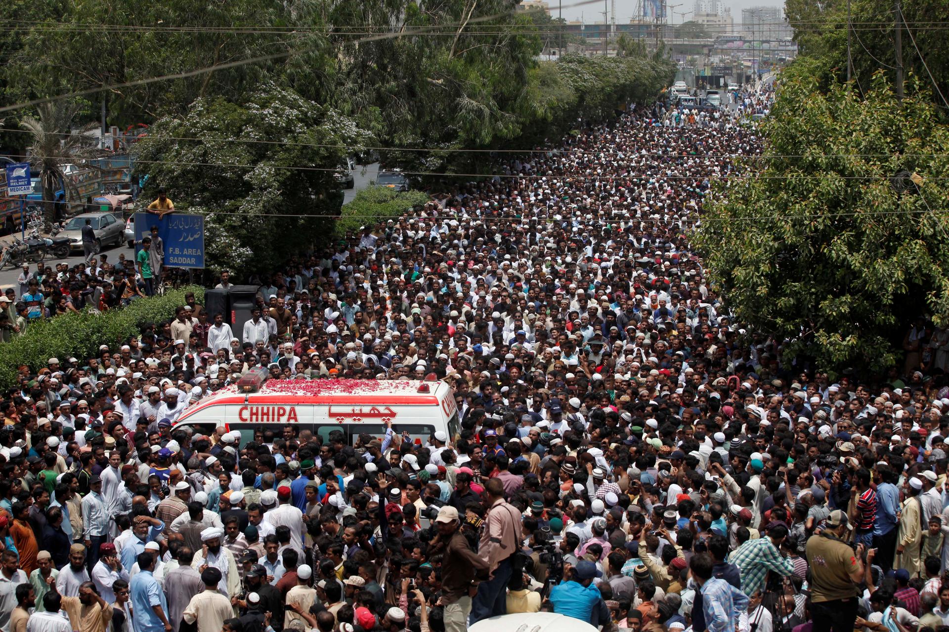 Thousands of people attend the funeral procession of Amjad Sabri, killed when unidentified gunmen open fire on his car in Karachi, Pakistan.
