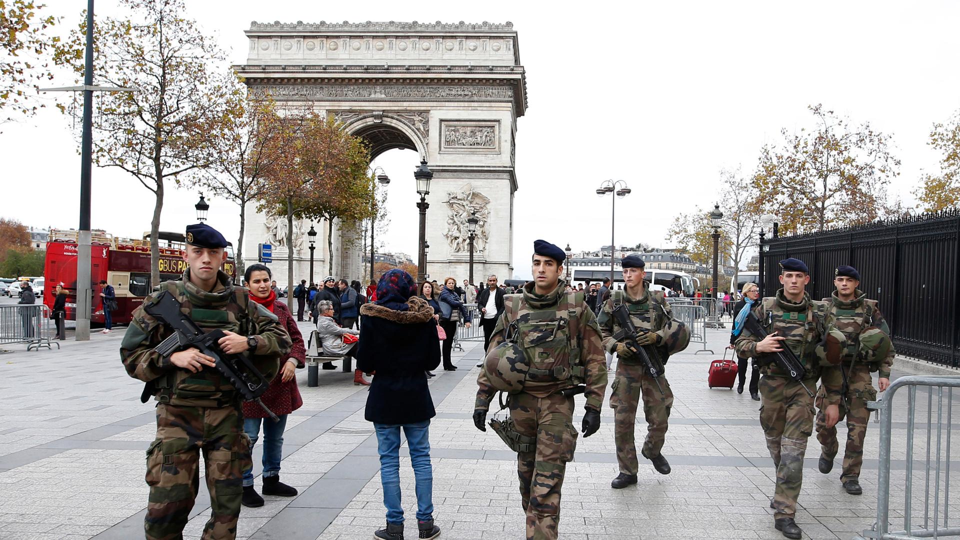 Soldiers patrol in front of the Arc de Triomphe on the Champs Elysees in Paris, France, November 16, 2015, as security increases after last Friday's series of deadly attacks in the French capital. 