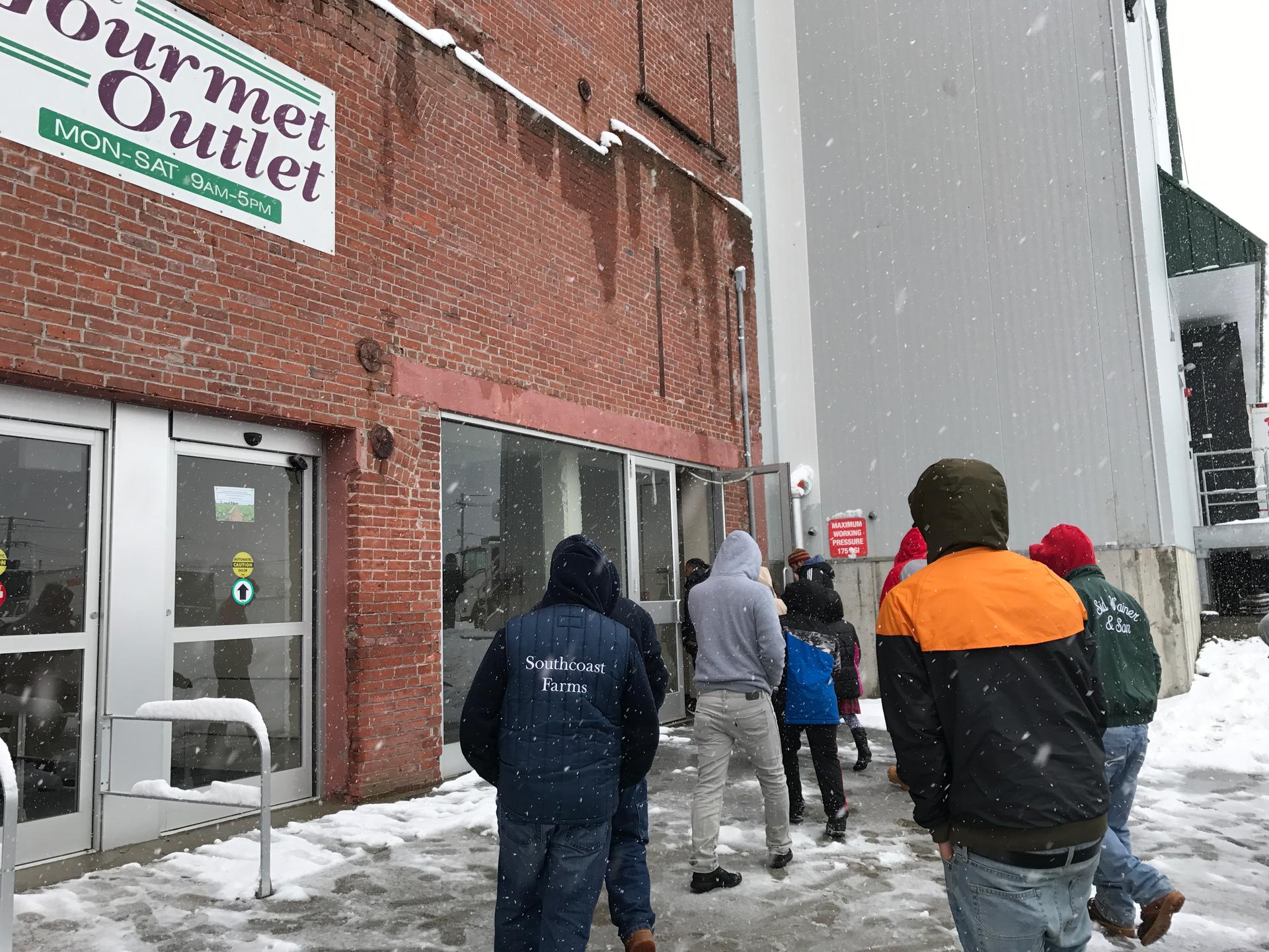Workers who have been fired gather at the management office for Sid Wainer & Son in New Bedford, Mass. on March 10, 2017. Most of the workers are undocumented, and felt their termination was unfair.
