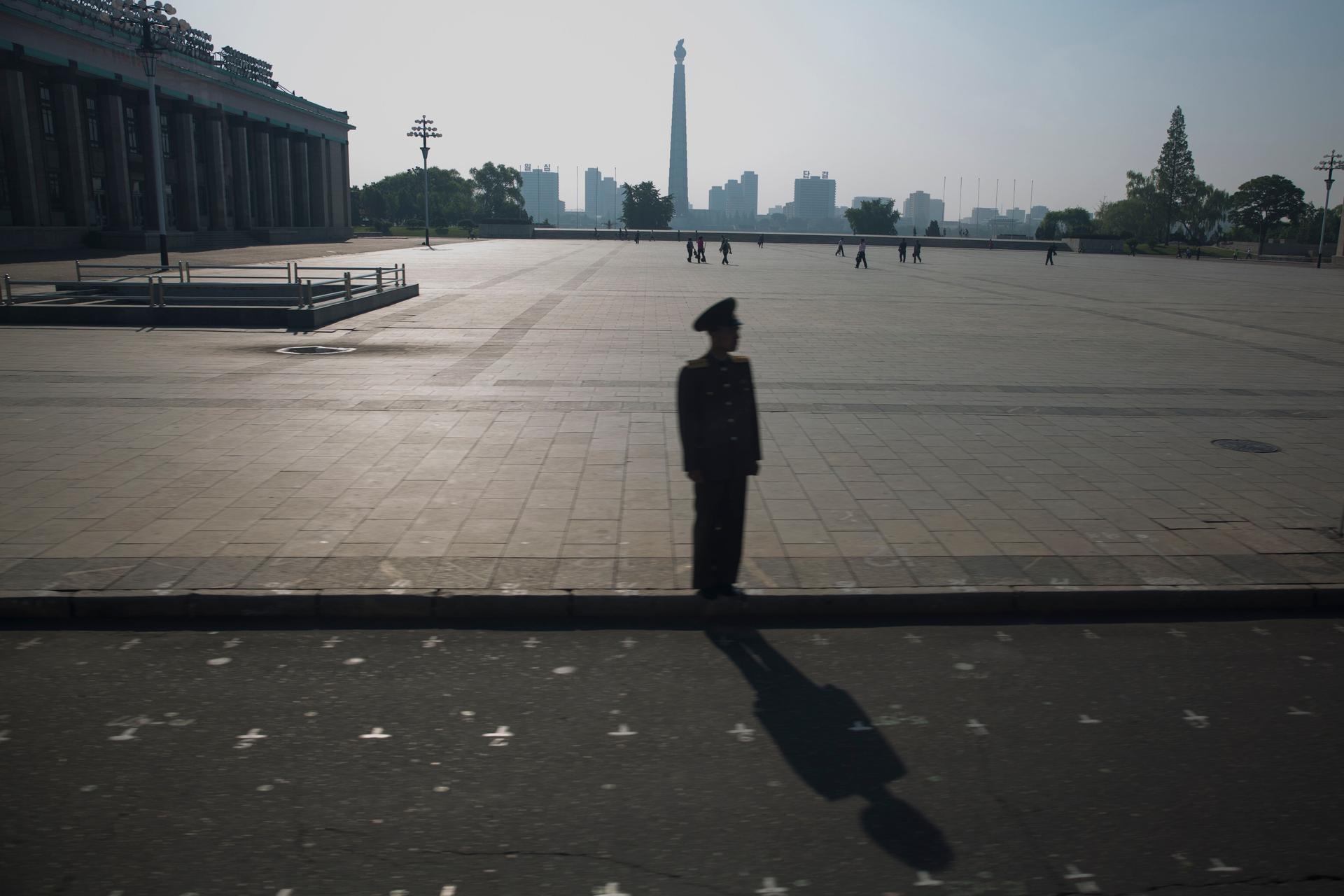 A North Korean soldier on Kim Il-sung Square in Pyongyang. The permanent markings on the street and square indicate marching steps for parades.