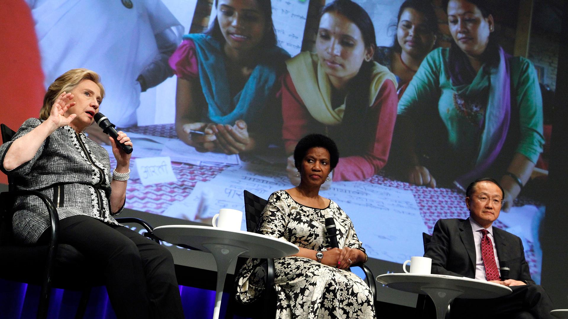 UN Women Executive Director Phumzile Mlambo-Ngcuka (C), former US Secretary of State Hillary Clinton (L) and World Bank Group President Jim Yong Kim (R) participate in an event on empowering woman and girls, at the World Bank. 