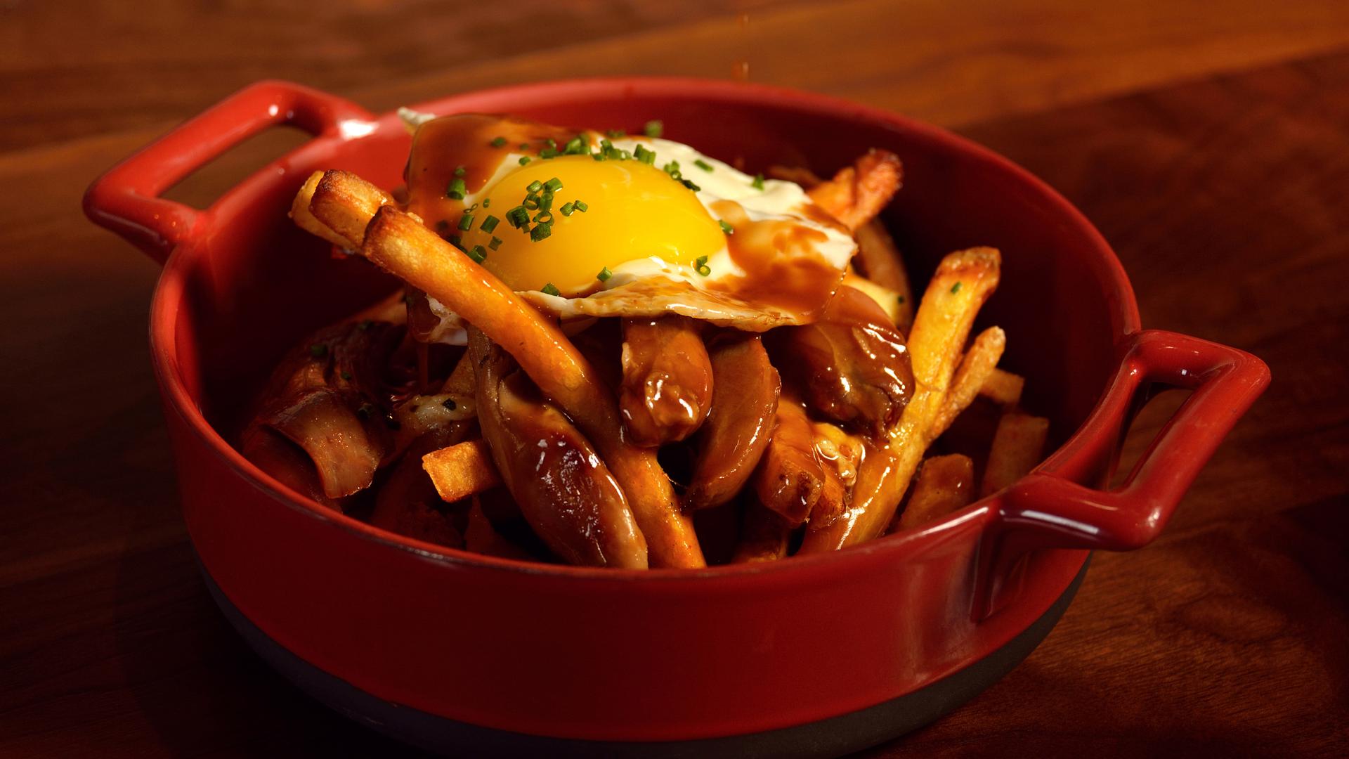 The poutine at the Public House at the Venetian Hotel in Las Vegas: fries topped with duck confit, stout gravy, cheese curd and a fried egg.
