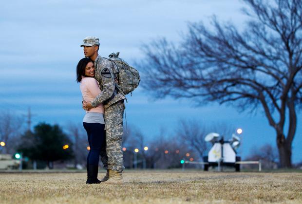 US soldier hugs his girlfriend at a homecoming ceremony