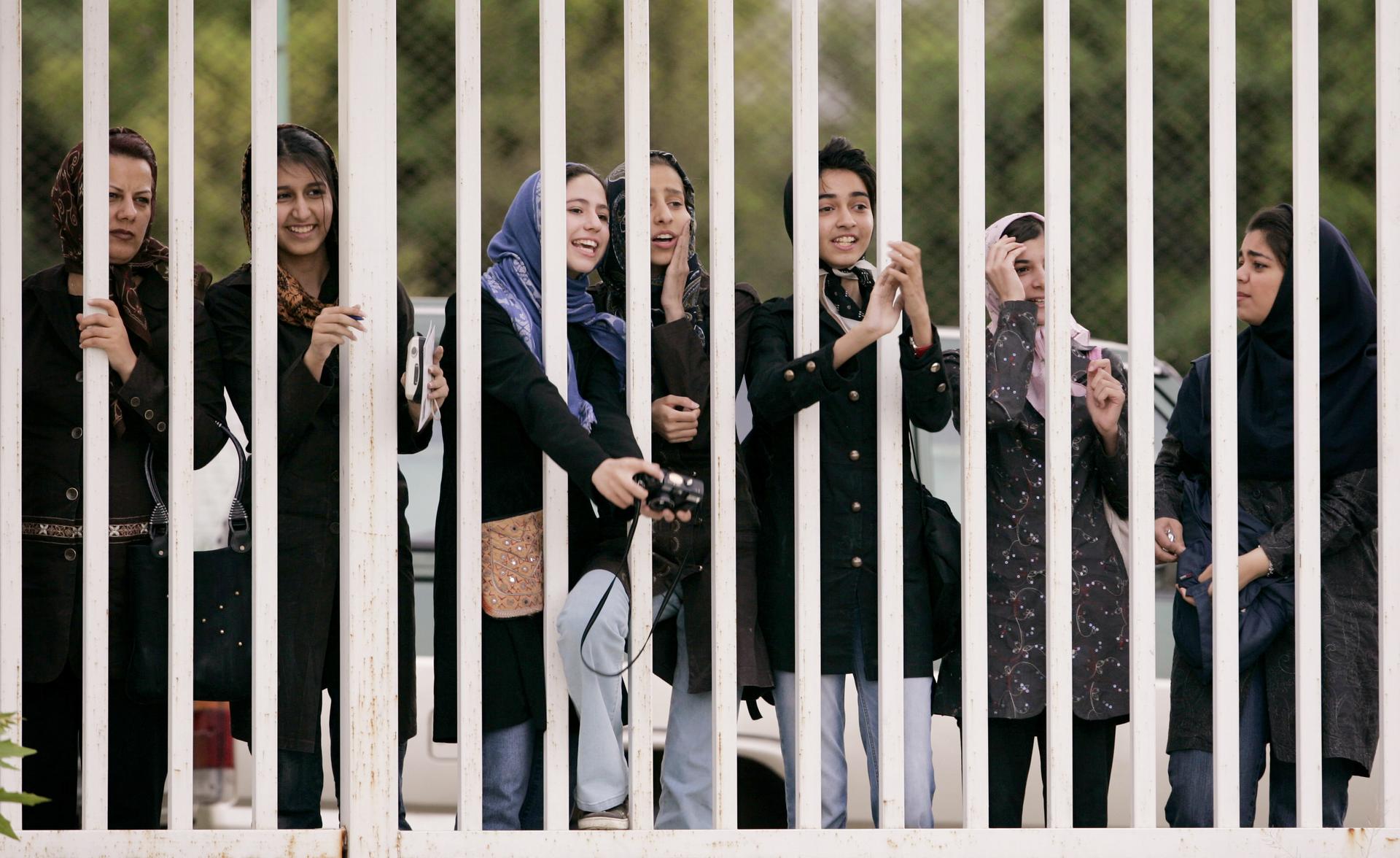 Iranian women watch Iran's national soccer team conduct a training session ahead of the 2006 World Cup.