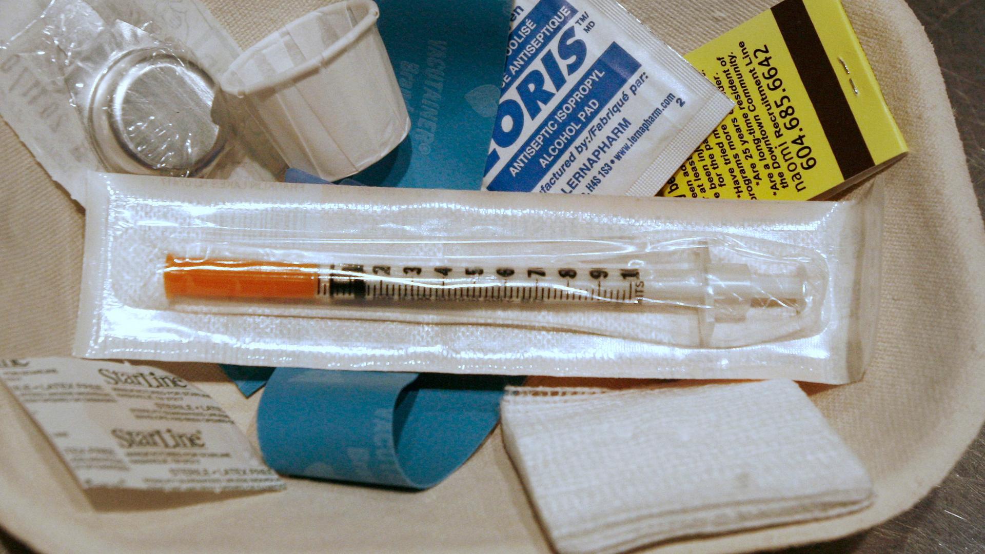 A small kit of supplies containing syringes, bandaids and antiseptic pads waits to be used by a drug addict inside a safe injection site on Vancouver, British Columbia's eastside August 23, 2006. Nearly a decade later, the city will be offering free heroi