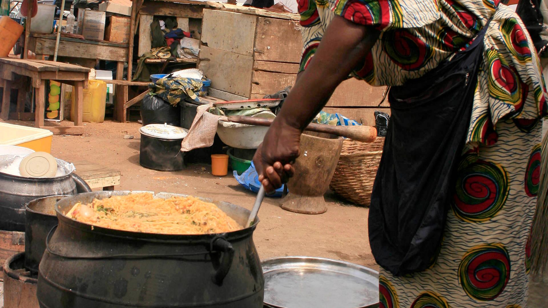 A food vendor prepares "jollof rice," a traditional meal usually made using chicken, in the northern city of Kano.