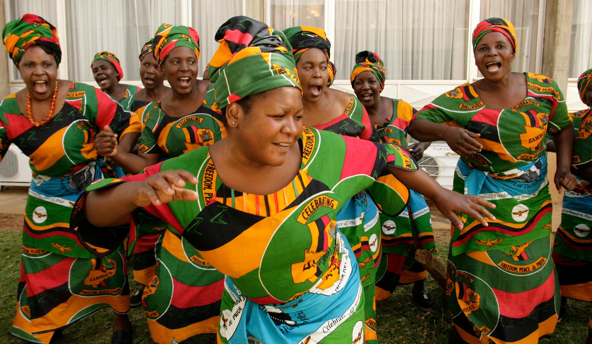 Zambian women sing at Lusaka's international airport in 2008.