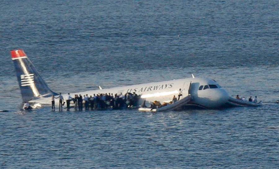 Passengers stand on the wings of a US Airways plane after it landed in the Hudson River in New York after a flock of birds struck the engines