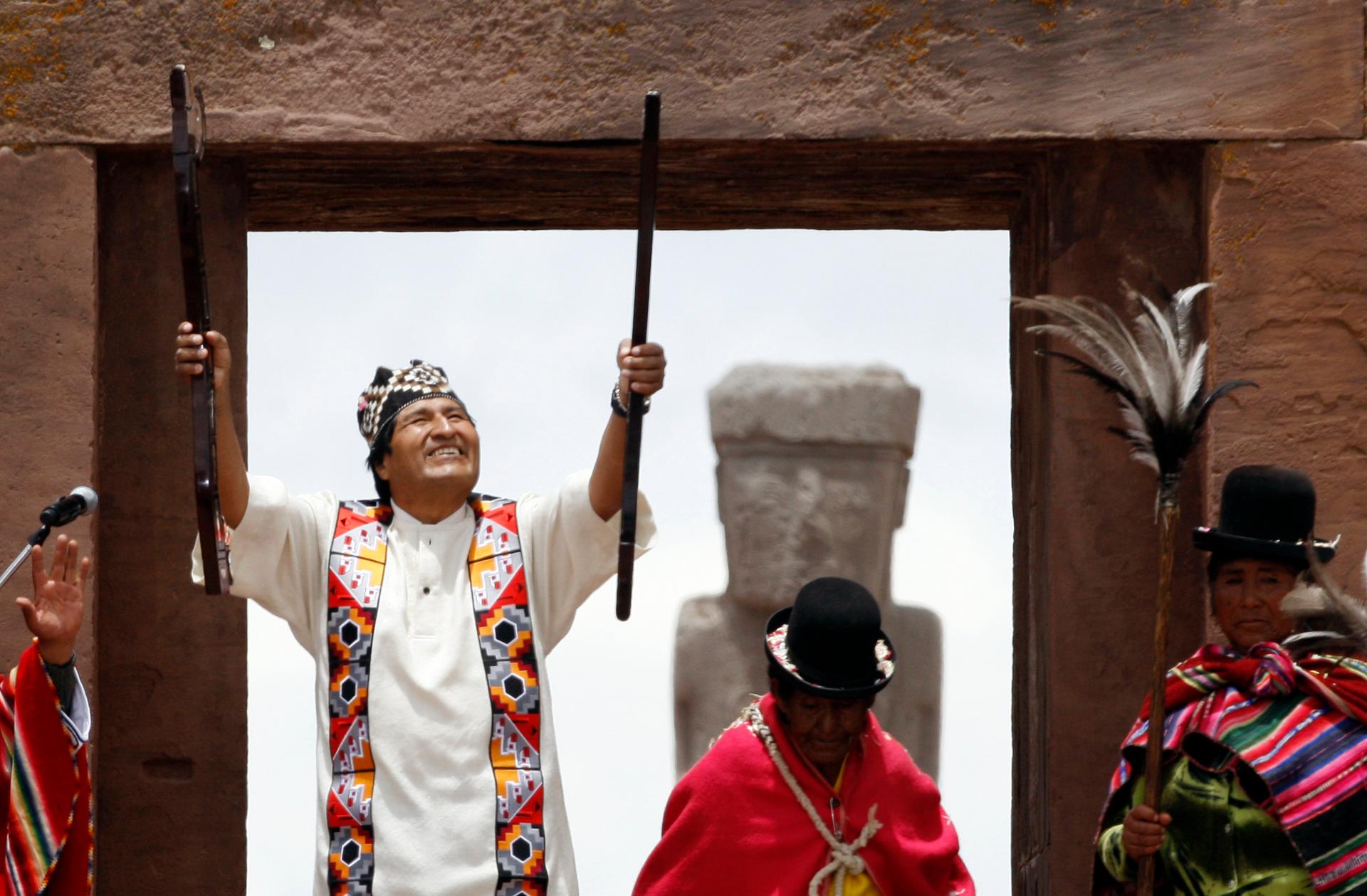After being elected for a second term, Bolivian re-elect President Evo Morales, accompanied by indigenous leaders, holds the staff of command during an Aymara indigenous ceremony at the ancient Kalasasaya Palace at Tiwanaku, January 21, 2010. The Kalasasa