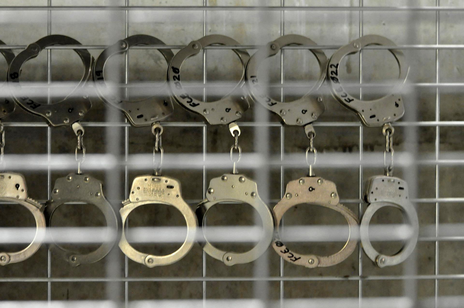 In this photo, reviewed by a U.S. Department of Defense official, handcuffs hang in Camp 6 high-security detention facility at Guantanamo Bay U.S. Naval Base April 27, 2010.