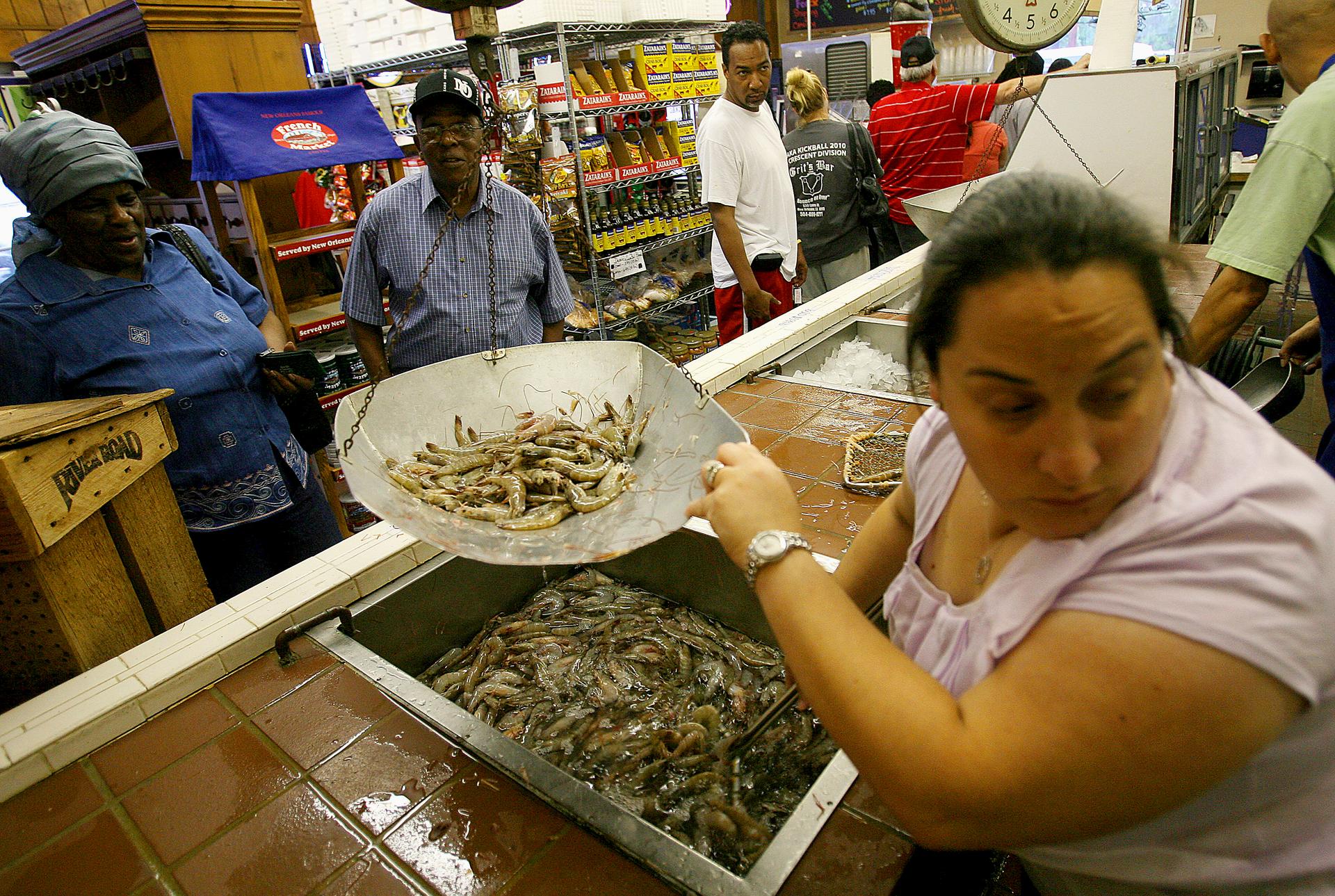 Chandra Chifici at Deanie's Seafood weighs shrimp for customers in Metairie, Louisiana, in 2010.