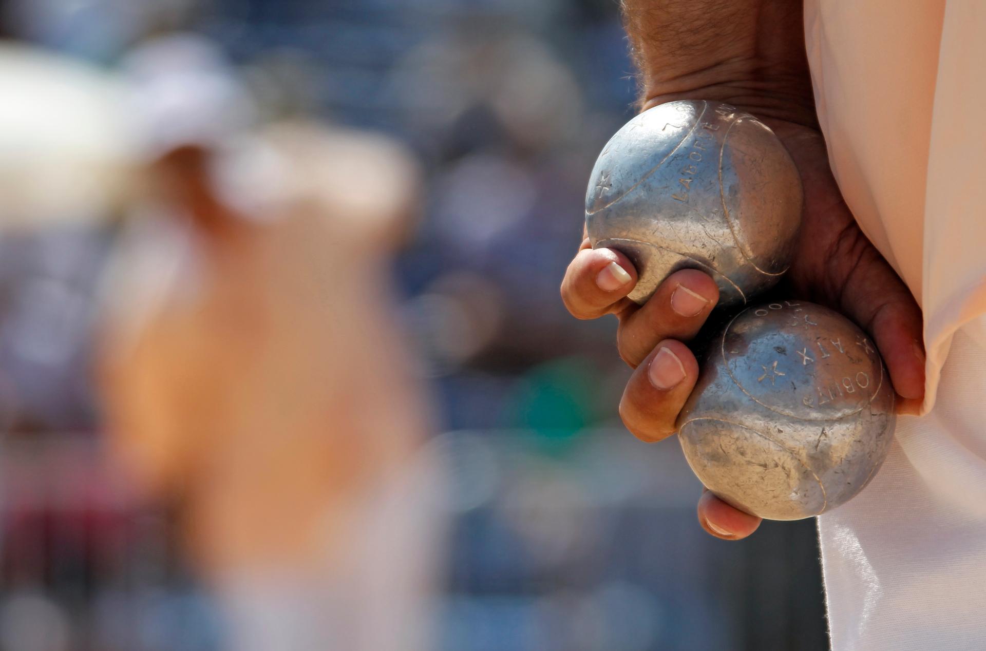 A player holds petanque bowls during the semi-final of the "Mondial La Marseillaise de Petanque" in Marseille July 8, 2010.