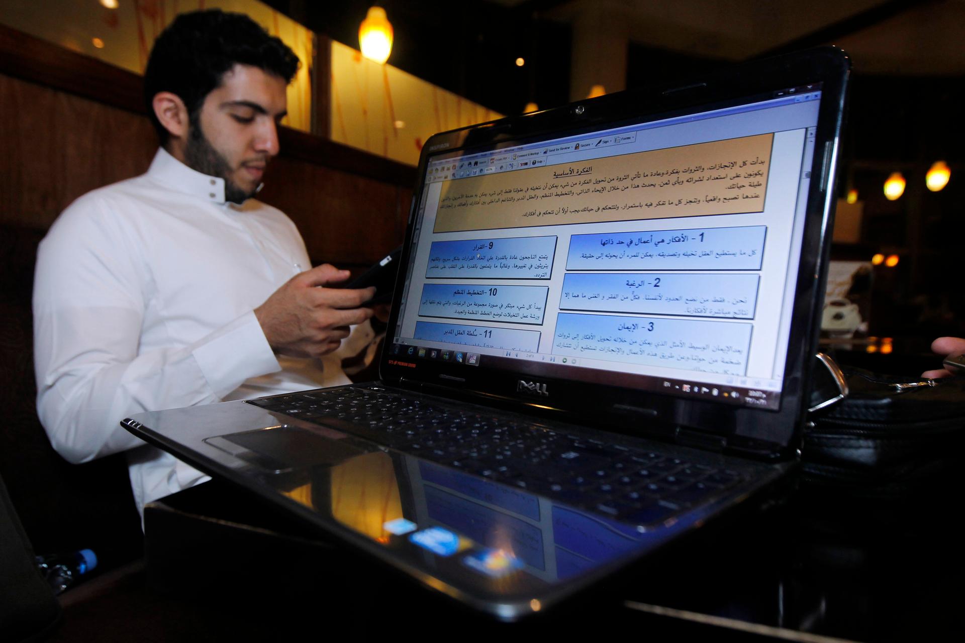 A Saudi man reads at a coffee shop in Riyadh, September 19, 2011.