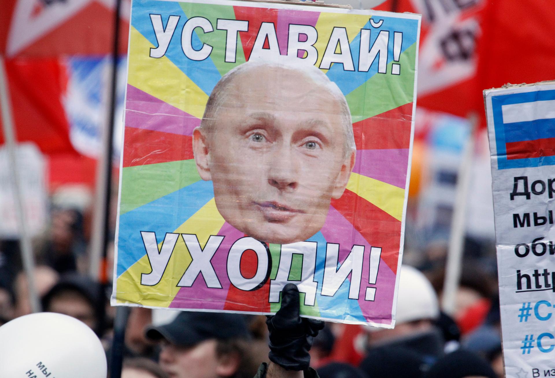 Anti-government Russian demonstrators took to the streets in Decembe, 2011, increasing pressure on Vladimir Putin as he sought a new term as Russian president. The placard reads "Get tired! Leave!"