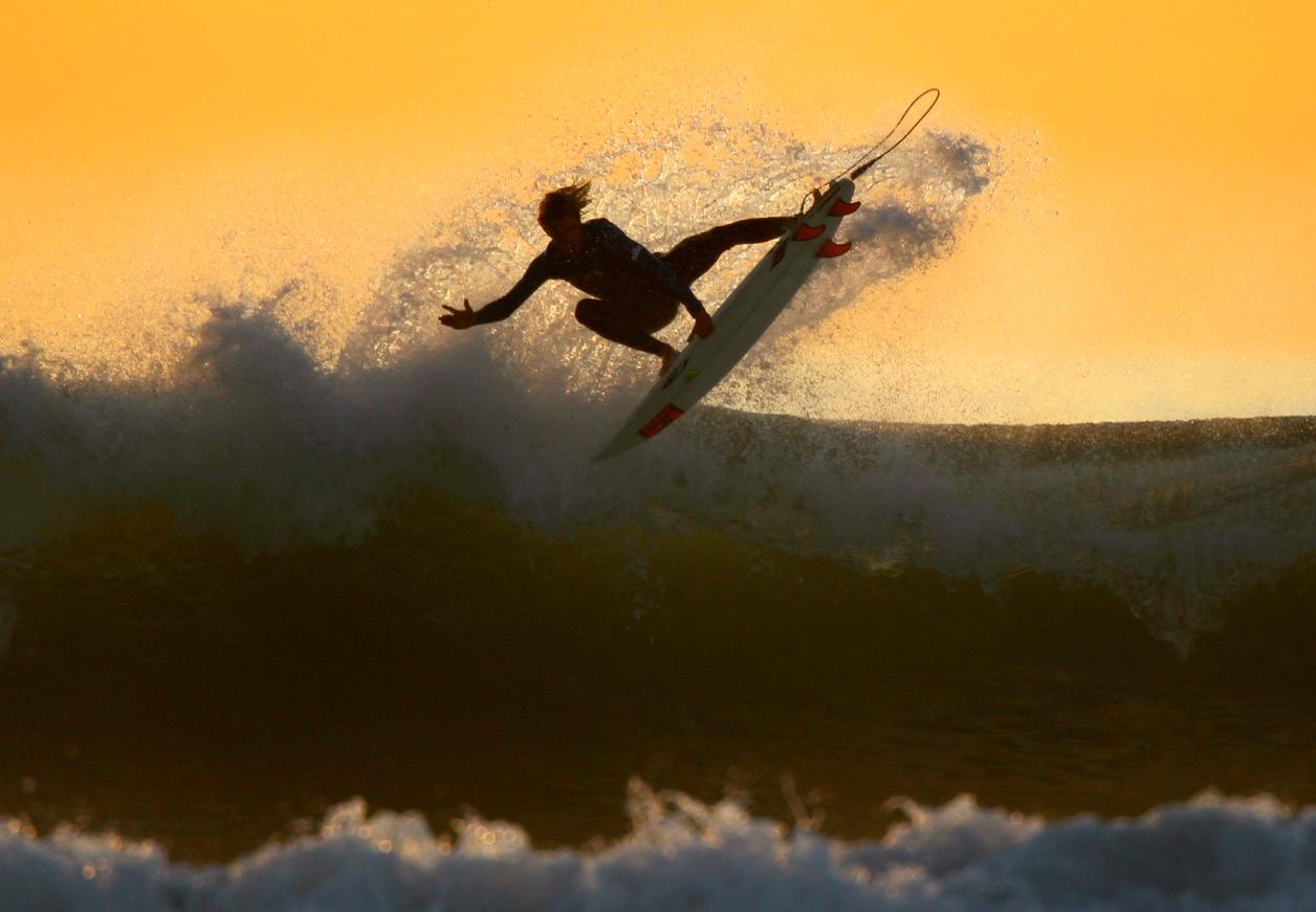 Surfing on the California coastline at dusk in Cardiff.