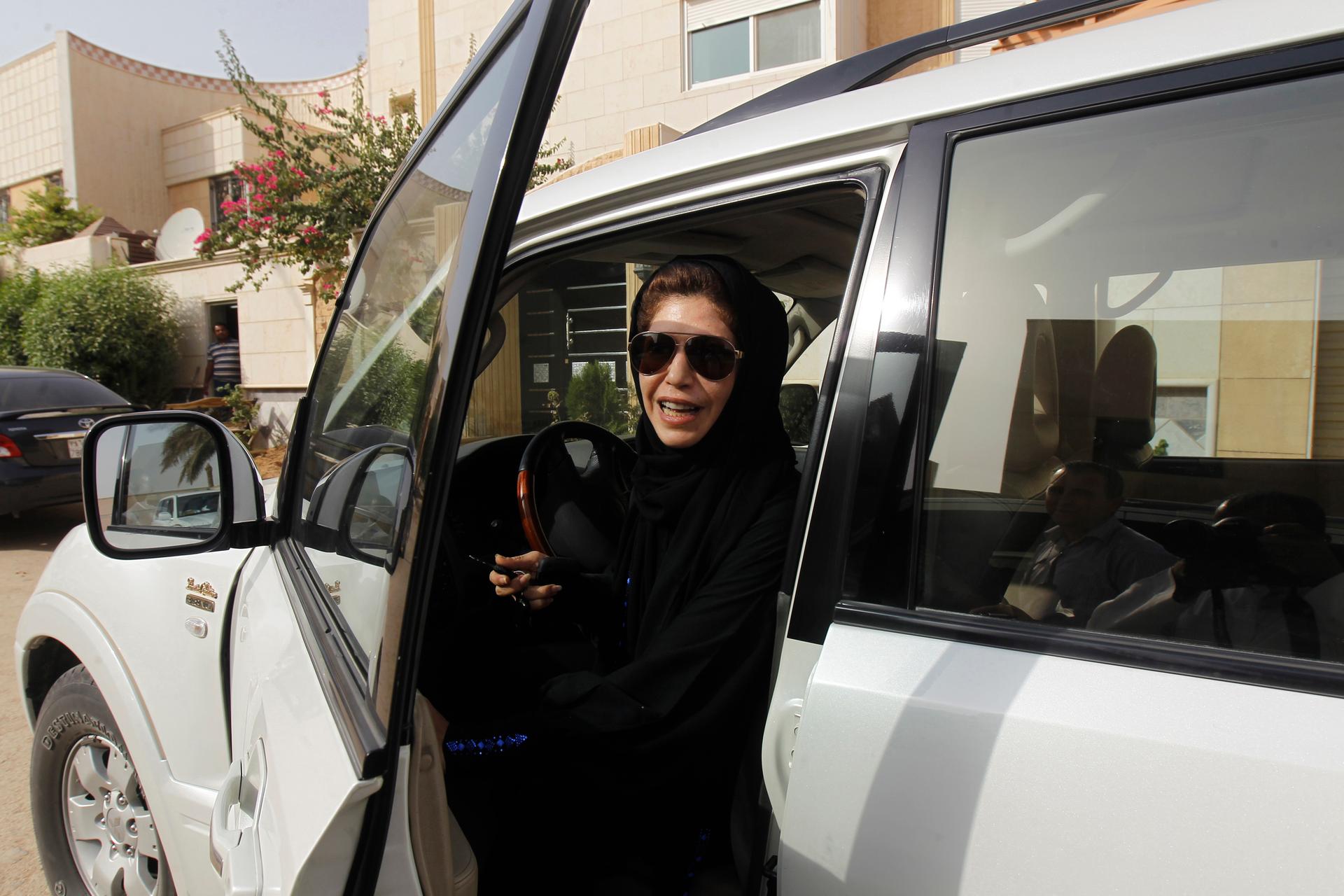 Azza Al Shmasani alights from her car after driving in defiance of the ban in Riyadh, Saudi Arabia in 2011.