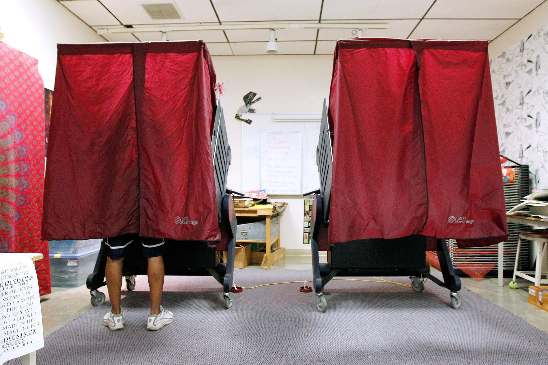 Two voting booths, red curtains drawn
