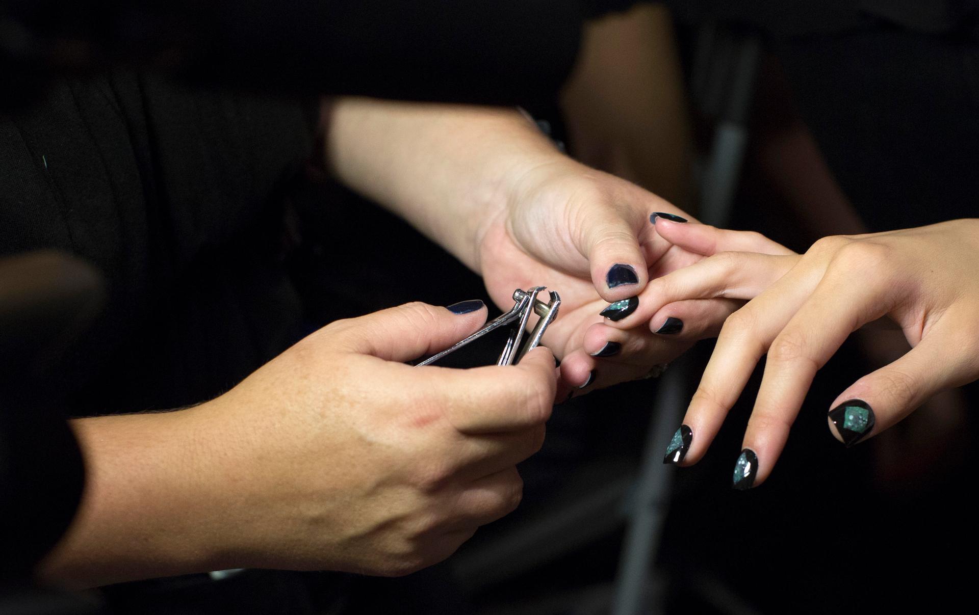 A model has her nails done backstage before the presentation of the Nicole Miller Spring/Summer 2013 collection during New York Fashion Week on September 7, 2012.