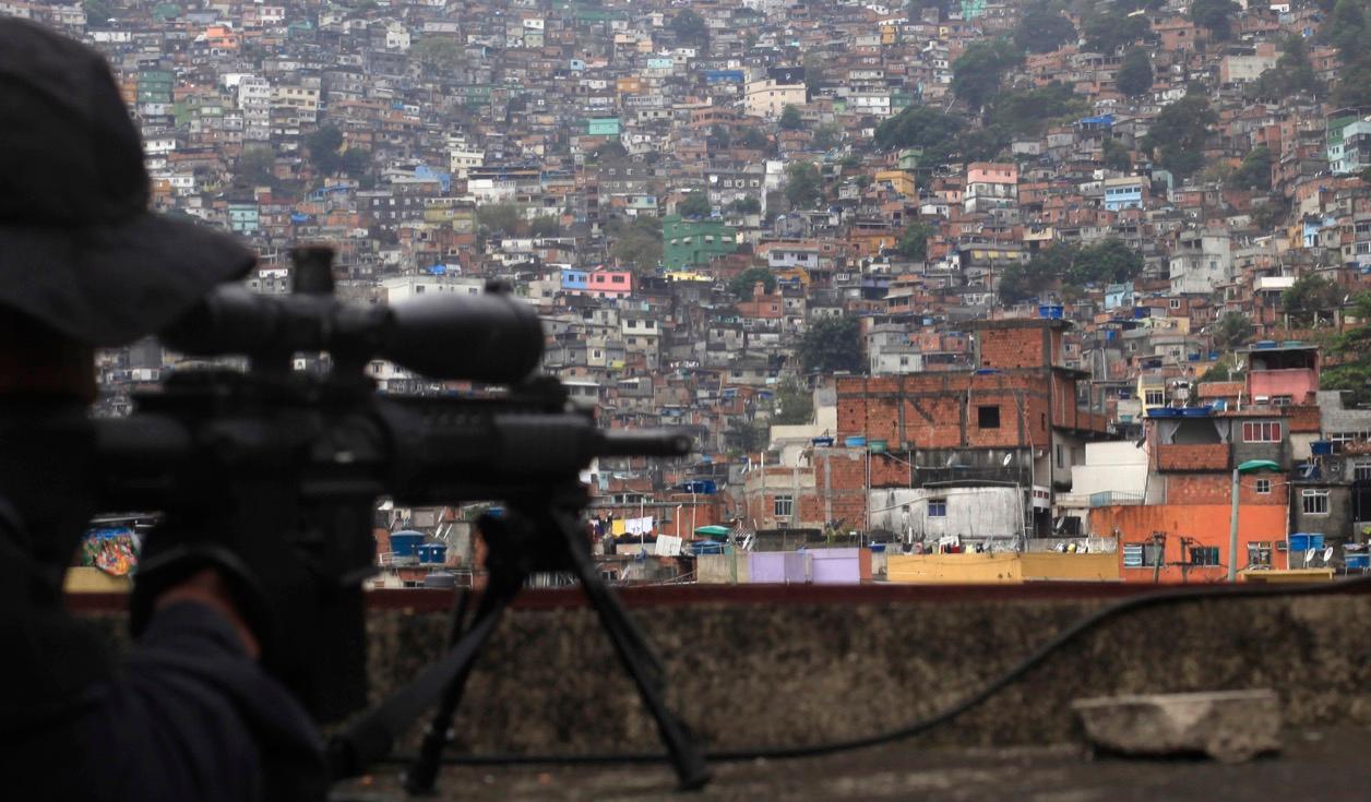 A sniper aims his gun at Rio de Janeiro's Rocinha slum during the inauguration of its so-called peacekeeping unit program in September 2012.
