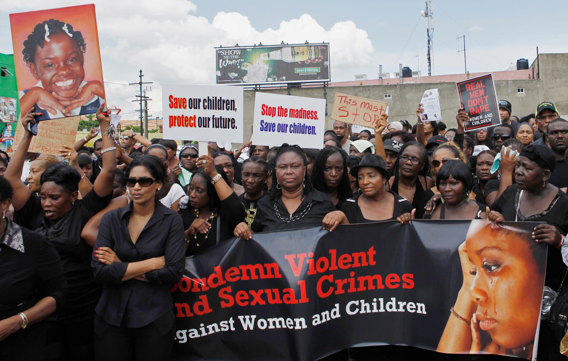 Jamaicans take part in a demonstration against the rape of three children and two women in Kingston in 2012. 
