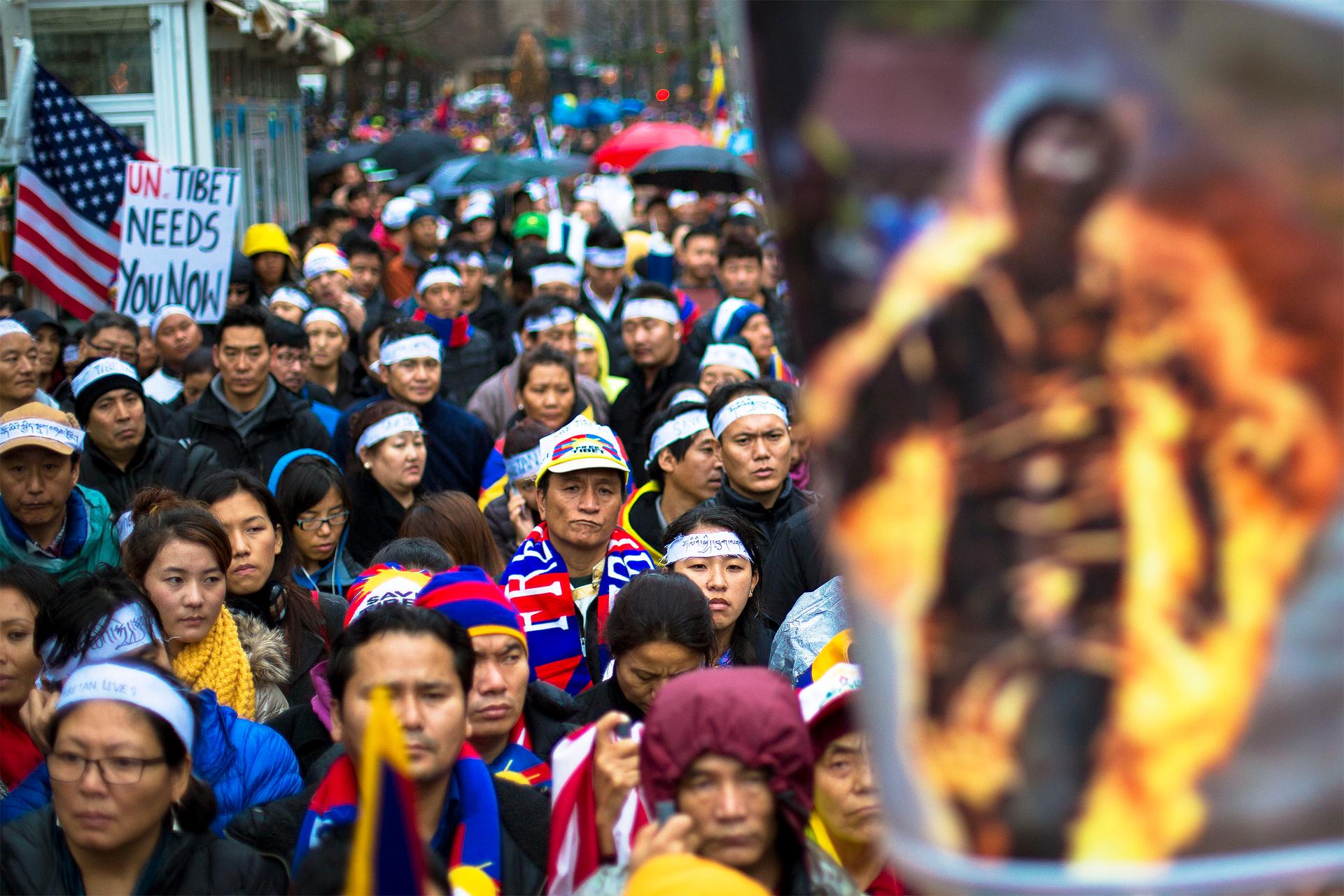 Protesters stand behind a photo of a victim of self-immolation during a 2012 march in New York City in support of Tibet.