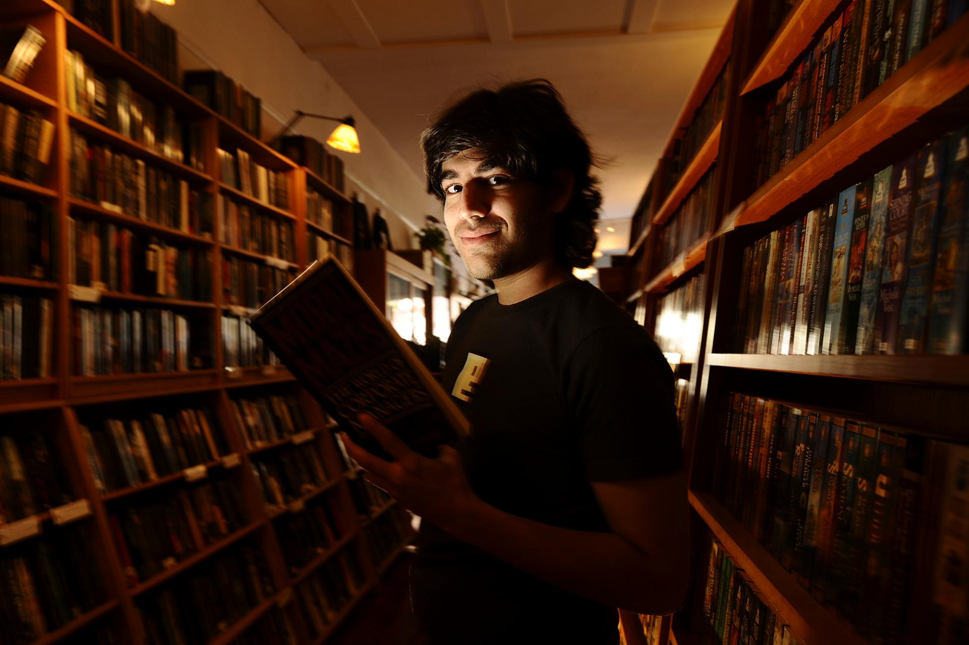 Aaron Swartz poses in a Borderland Books in San Francisco. The Internet activist is the subject of new documentary about his life, activism and death.