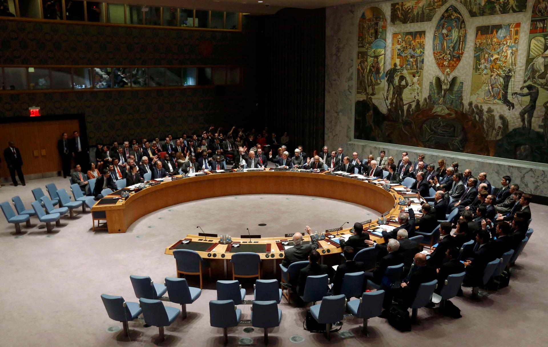 Members of the United Nations Security Council vote unanimously to approve a resolution on Syria's chemical arsenal on September 27, 2013.