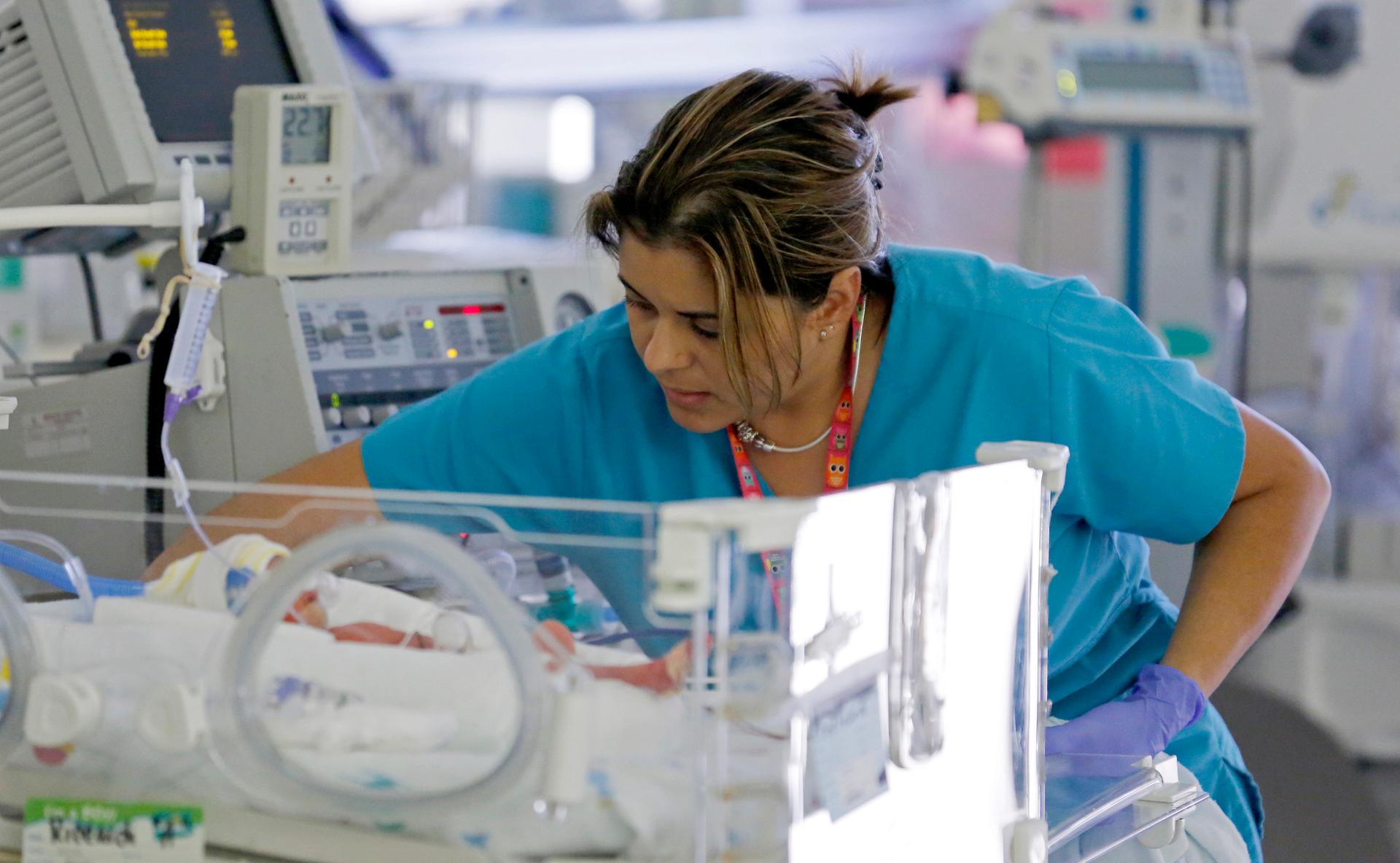 A nurse attends to an infant in the neonatal intensive care unit of the Holtz Children's Hospital at Jackson Memorial Hospital in Miami.