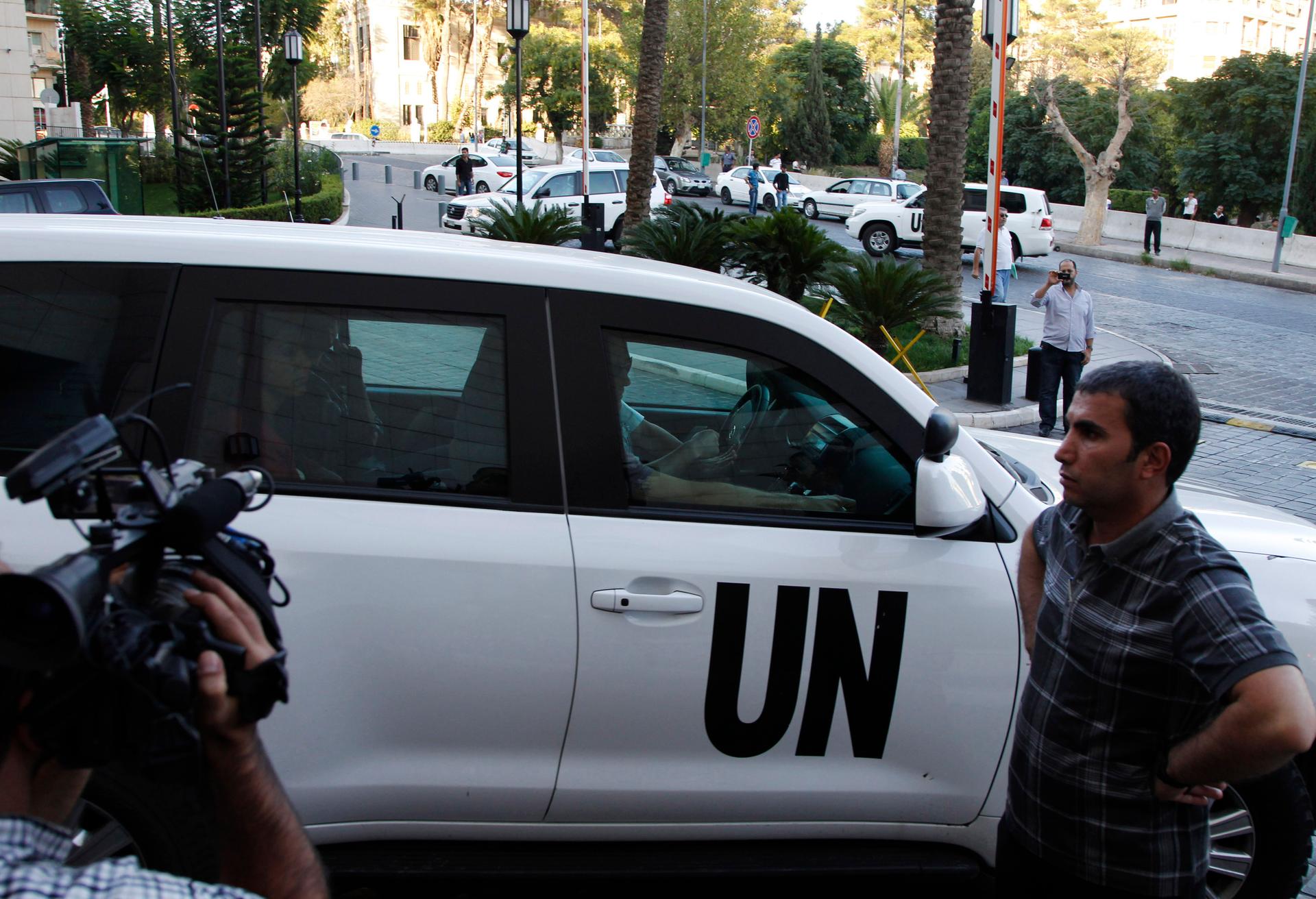 A U.N. convoy transporting a team of United Nations experts charged with starting the process of verifying and eliminating chemical weapons arrives at a hotel in Damascus on October 1, 2013. 