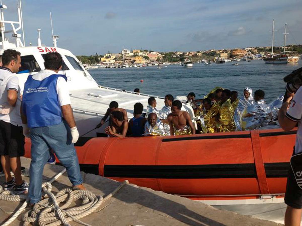 Rescued migrants on board a coastguard vessel arrive at the harbor of Lampedusa.