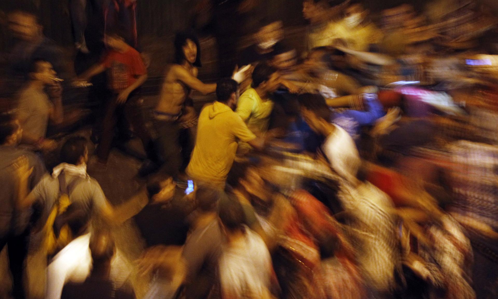 Anti-Mursi protesters clash with members of the Muslim Brotherhood near Tahrir Square on October 6, 2013.
