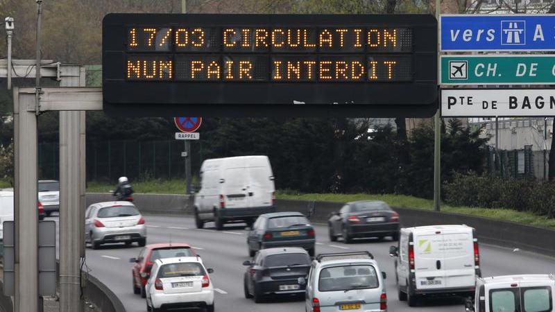 An electronic sign above a Paris highway on March 17 reads "Road traffic forbidden for even-numbered license plates." Public transportation was free and drivers of cars with even-numbered license plates faced fines as authorities sought to reduce air poll