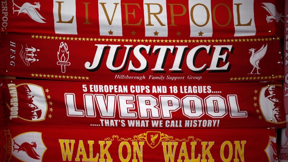 Liverpool scarves, including one asking for justice for the victims of the Hillsborough disaster, are seen for sale on a stall outside Anfield Stadium in Liverpool, England.