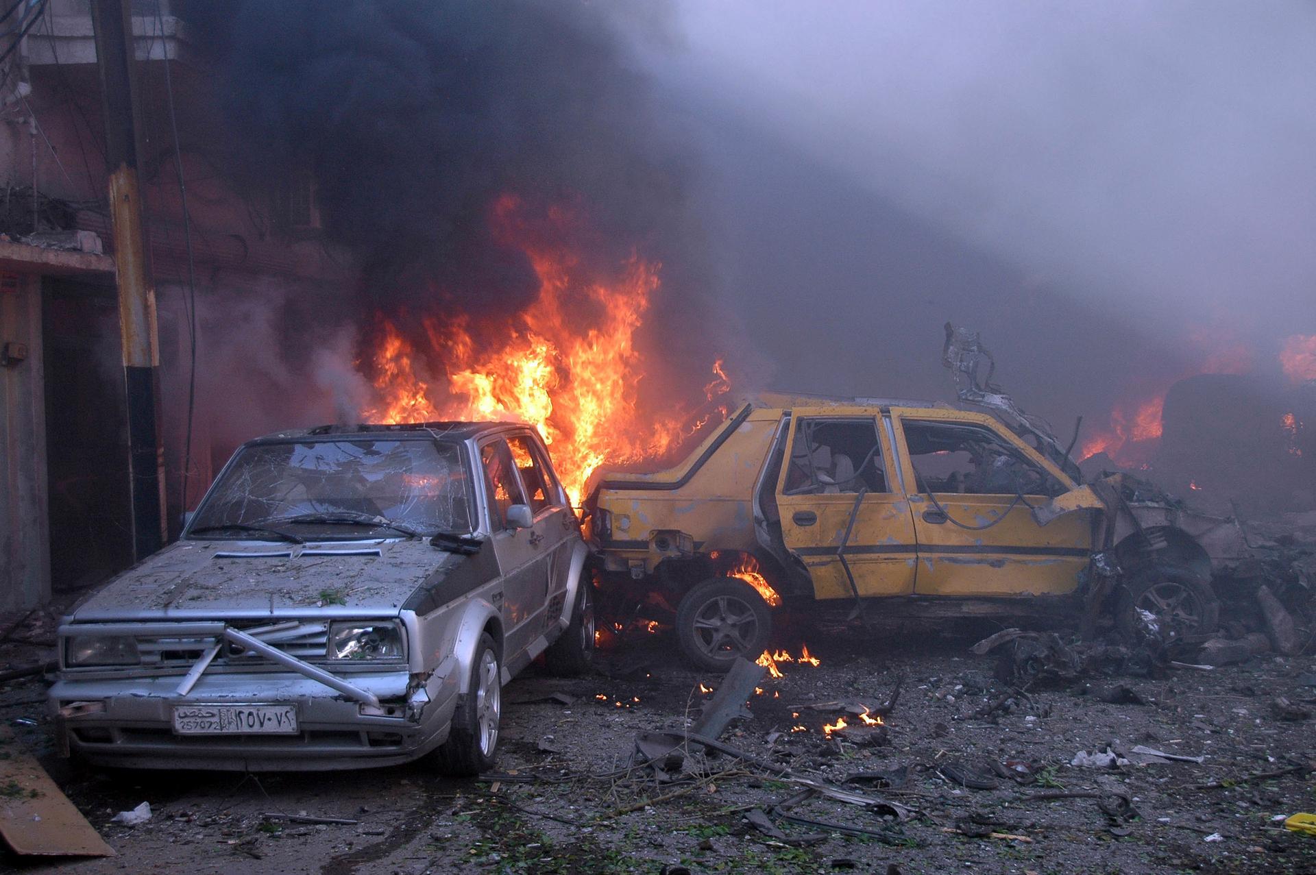 Vehicles burn after two car bombs exploded in the Karm al-Louz neighbourhood in Homs.