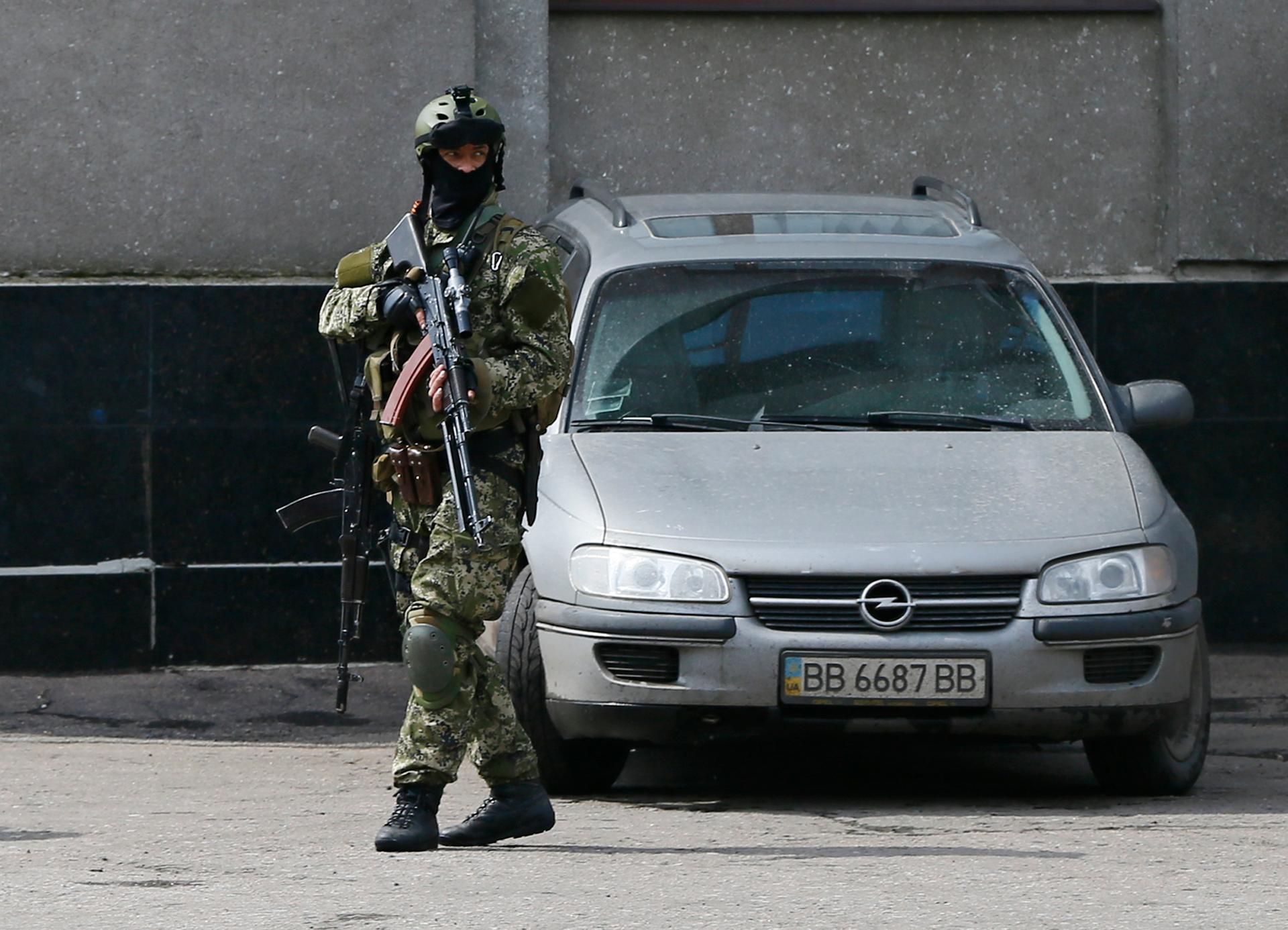 A pro-Russian armed man stands guard on a street in Slavyansk, in the Donetsk region of eastern Ukraine. Professional-looking troops with specialized Russian weapons but no insignia are spreading across eastern Ukraine. 