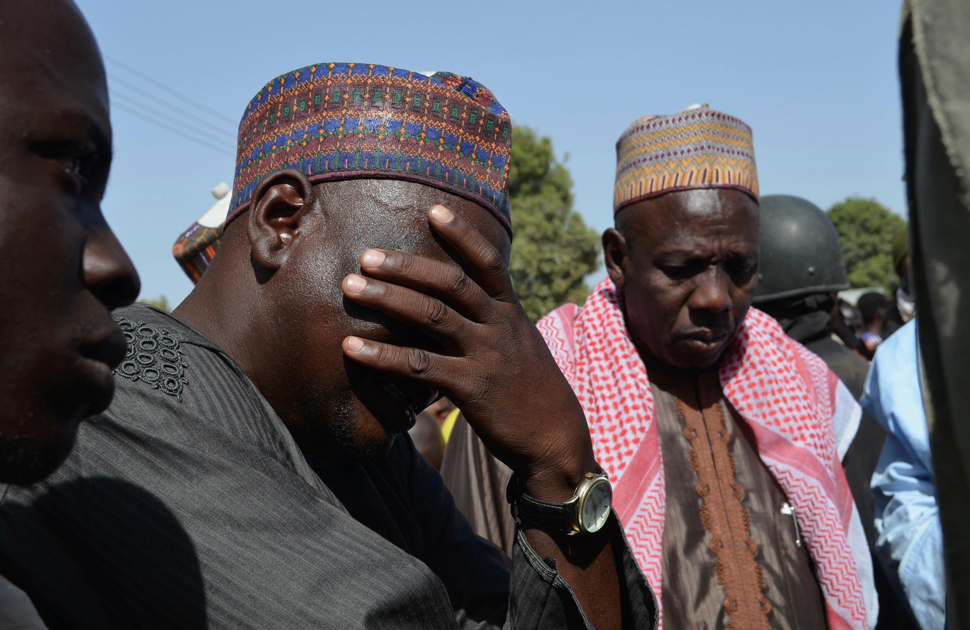 A man weeps with parents of kidnapped school girls abducted by Islamist militants.  Some 230 girls are still missing, a much higher figure than authorities originally said had been kidnapped.