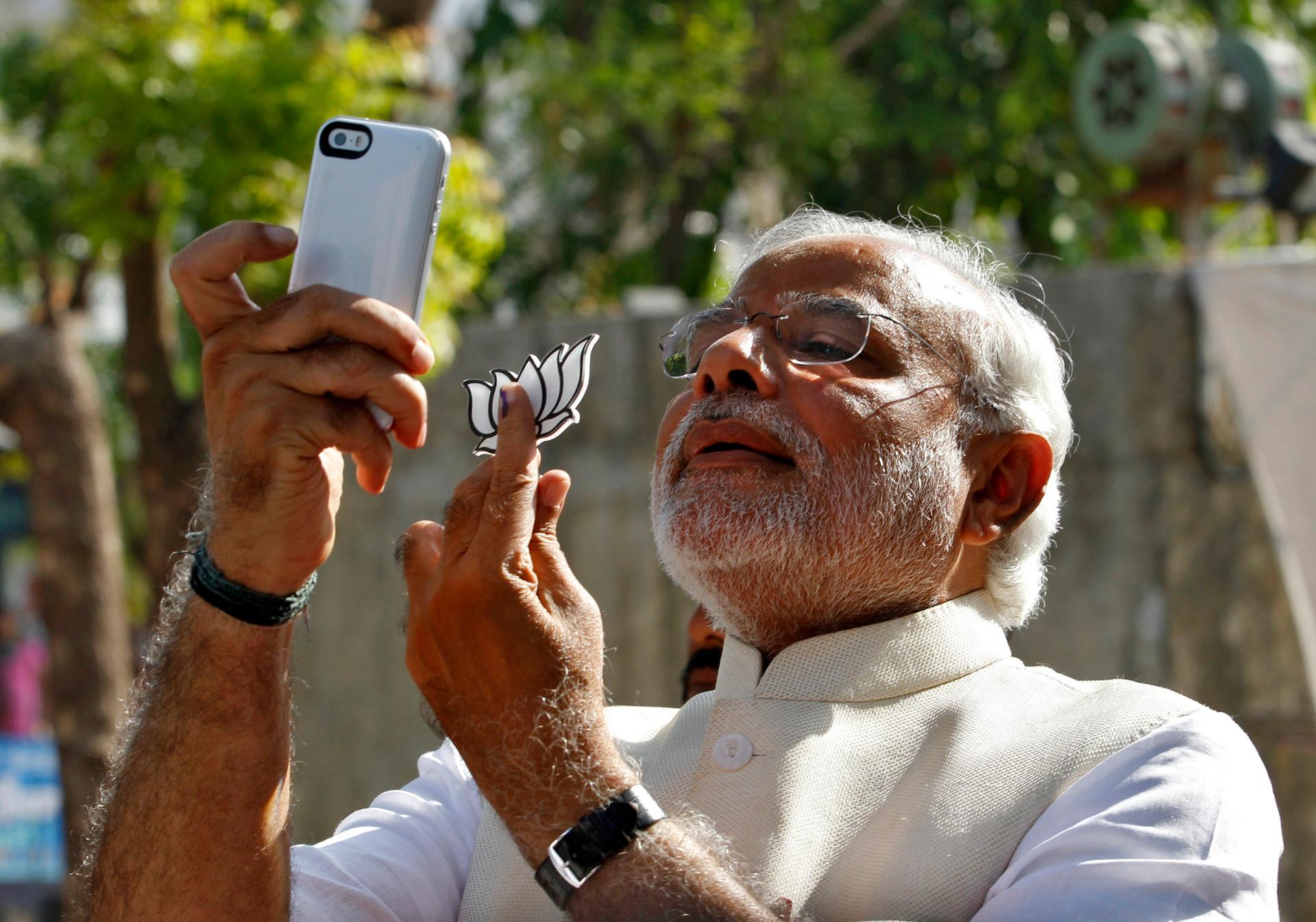 Hindu nationalist Narendra Modi, the prime ministerial candidate for India's main opposition Bharatiya Janata Party (BJP), takes a "selfie" after casting his vote at a polling station during the seventh phase of India's general election.