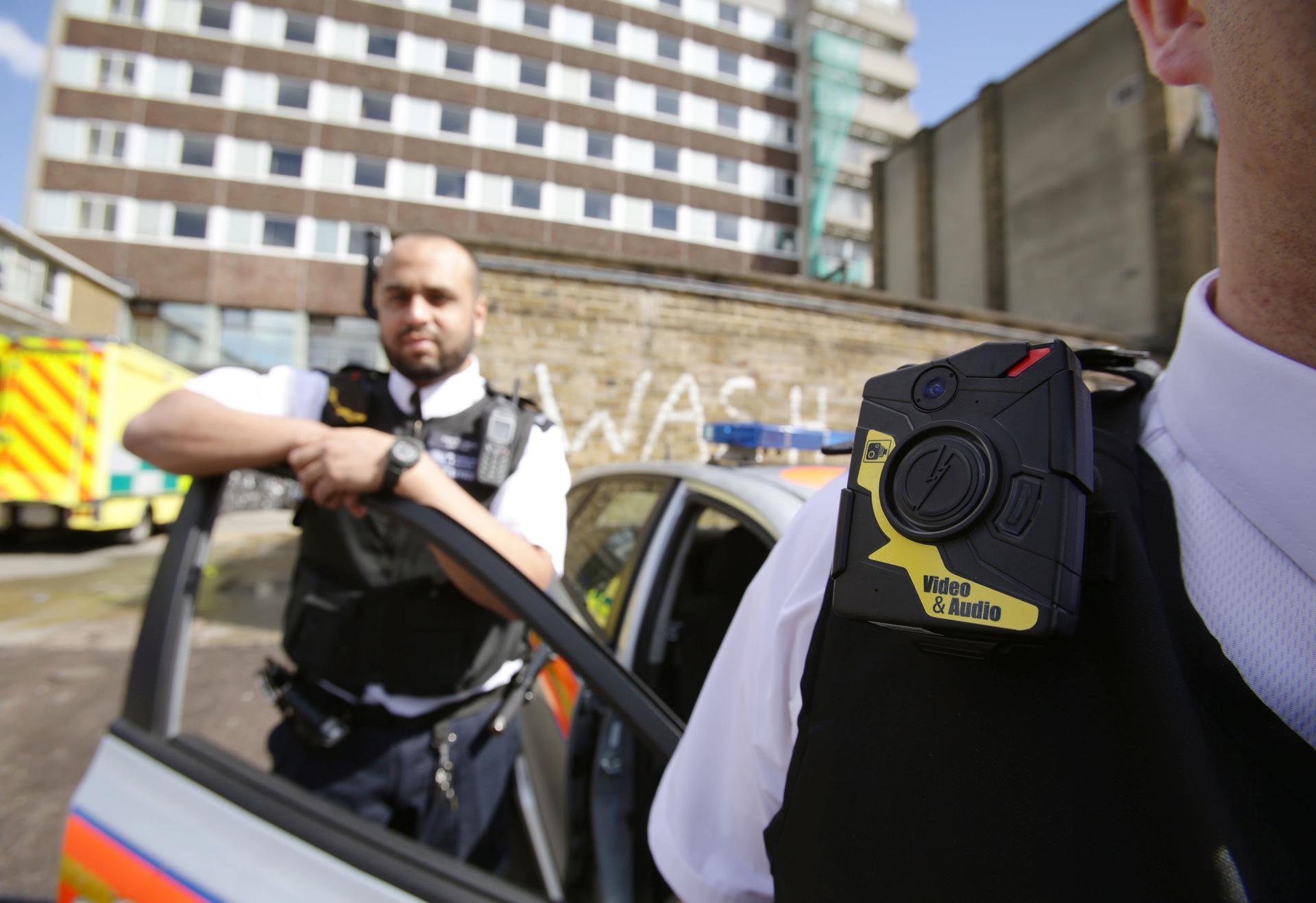 Two London police officers wearing a body-worn video cameras.
