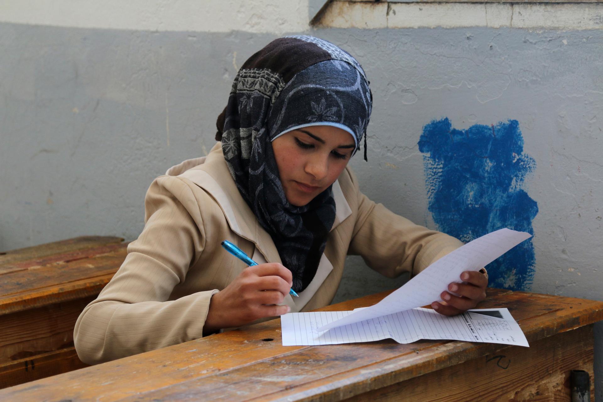 A student takes a test in Hama, Syria.  Despite the ongoing war, students in many parts of Syria are taking comprehensive exams. 
